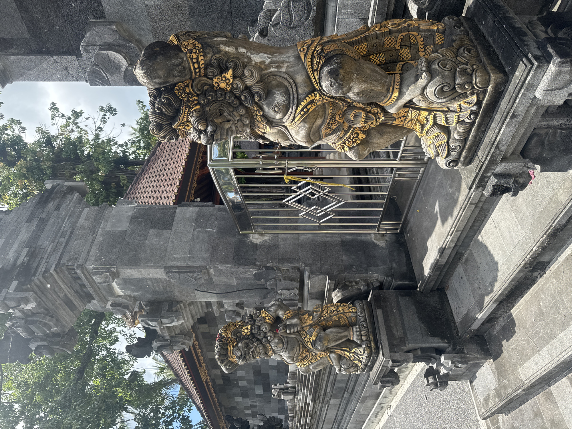 Tourist documents Balinese temple statues and coastal views in Nusa Penida