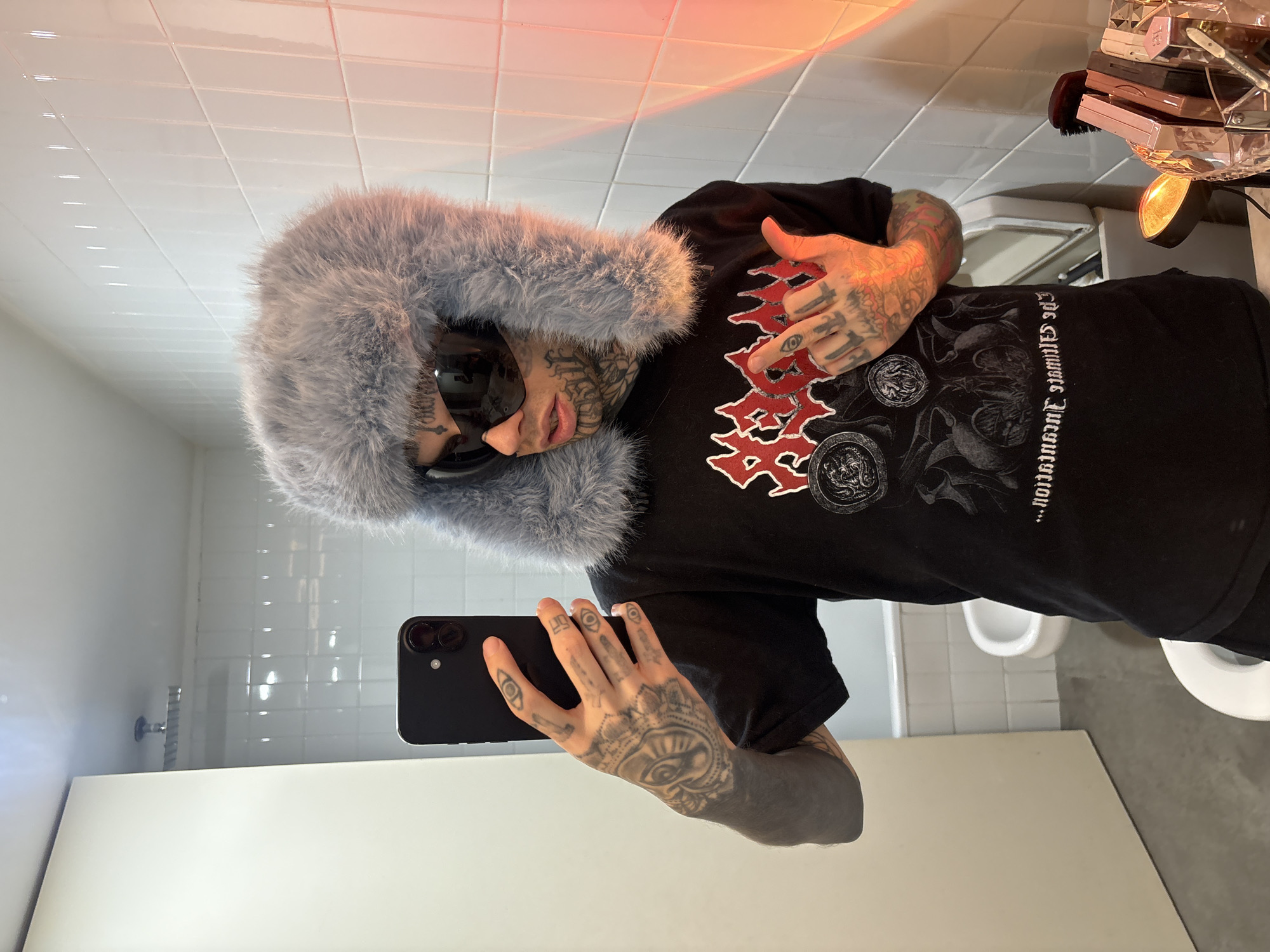 Tattooed individual photographed in Buenos Aires bathroom, bus departure recorded
