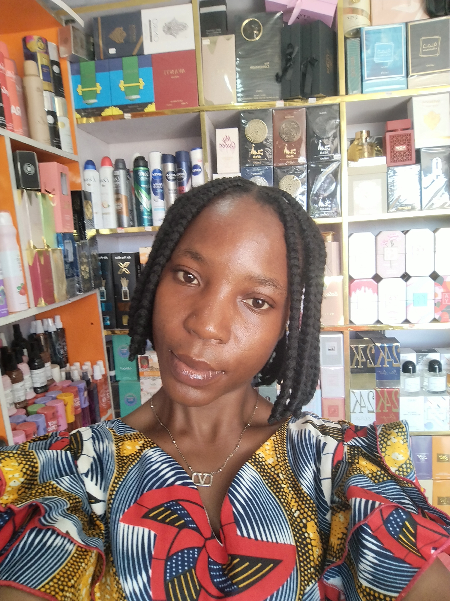 Selfies and shelf shots inside a Nigerian perfume shop