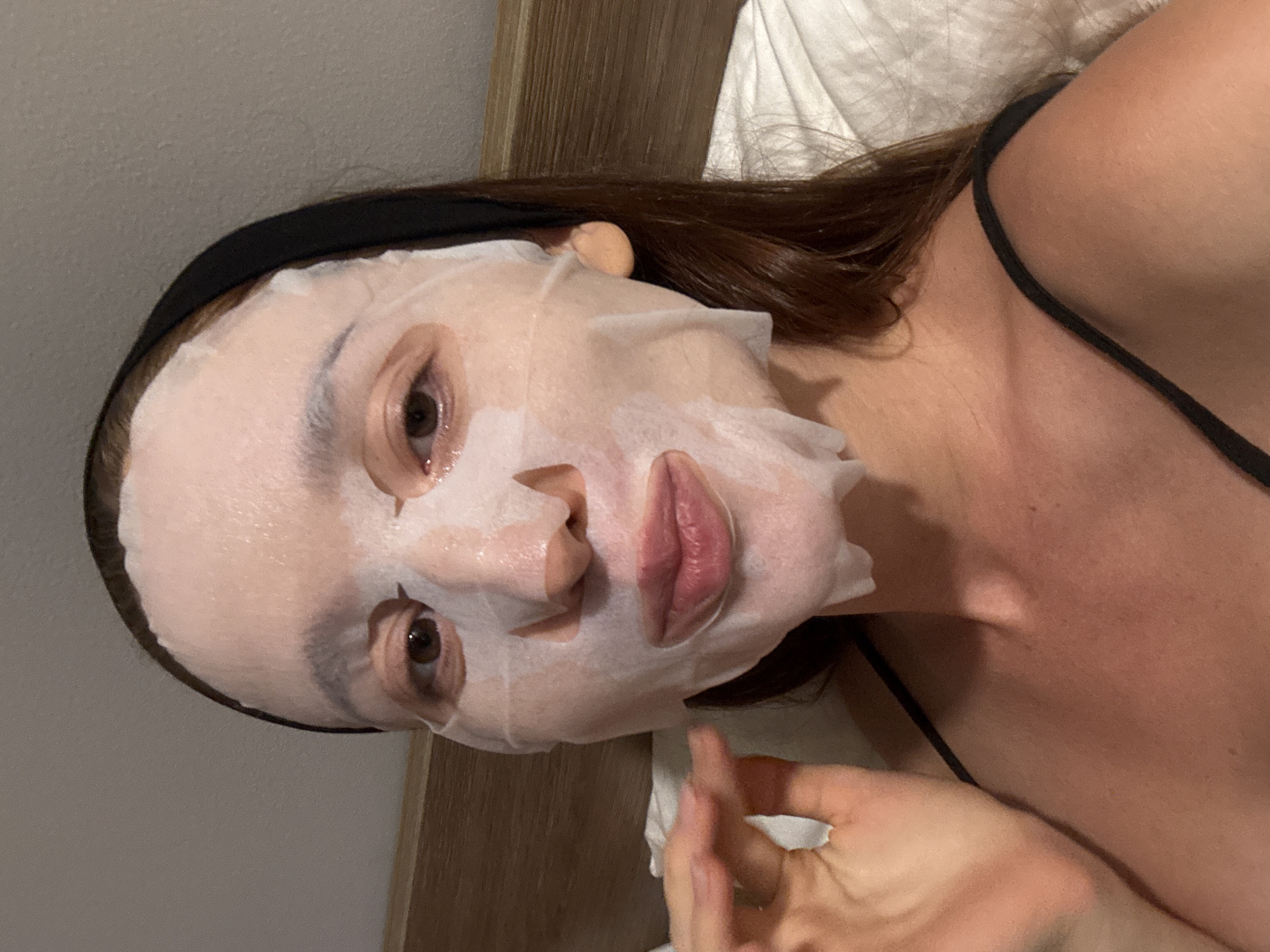 Woman documents skincare routine with sheet mask in Thailand