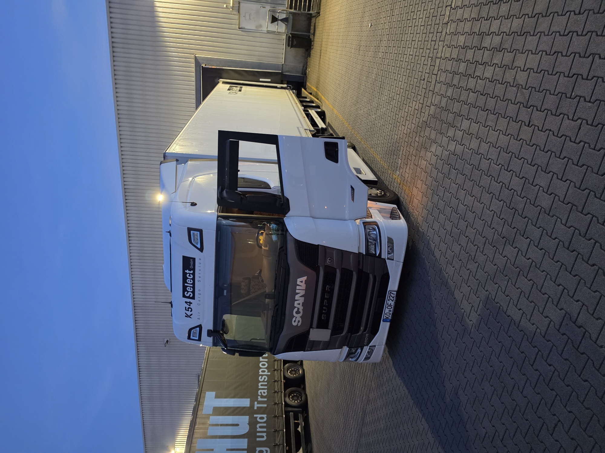 White Scania at a Zeppelinheim loading dock, late evening