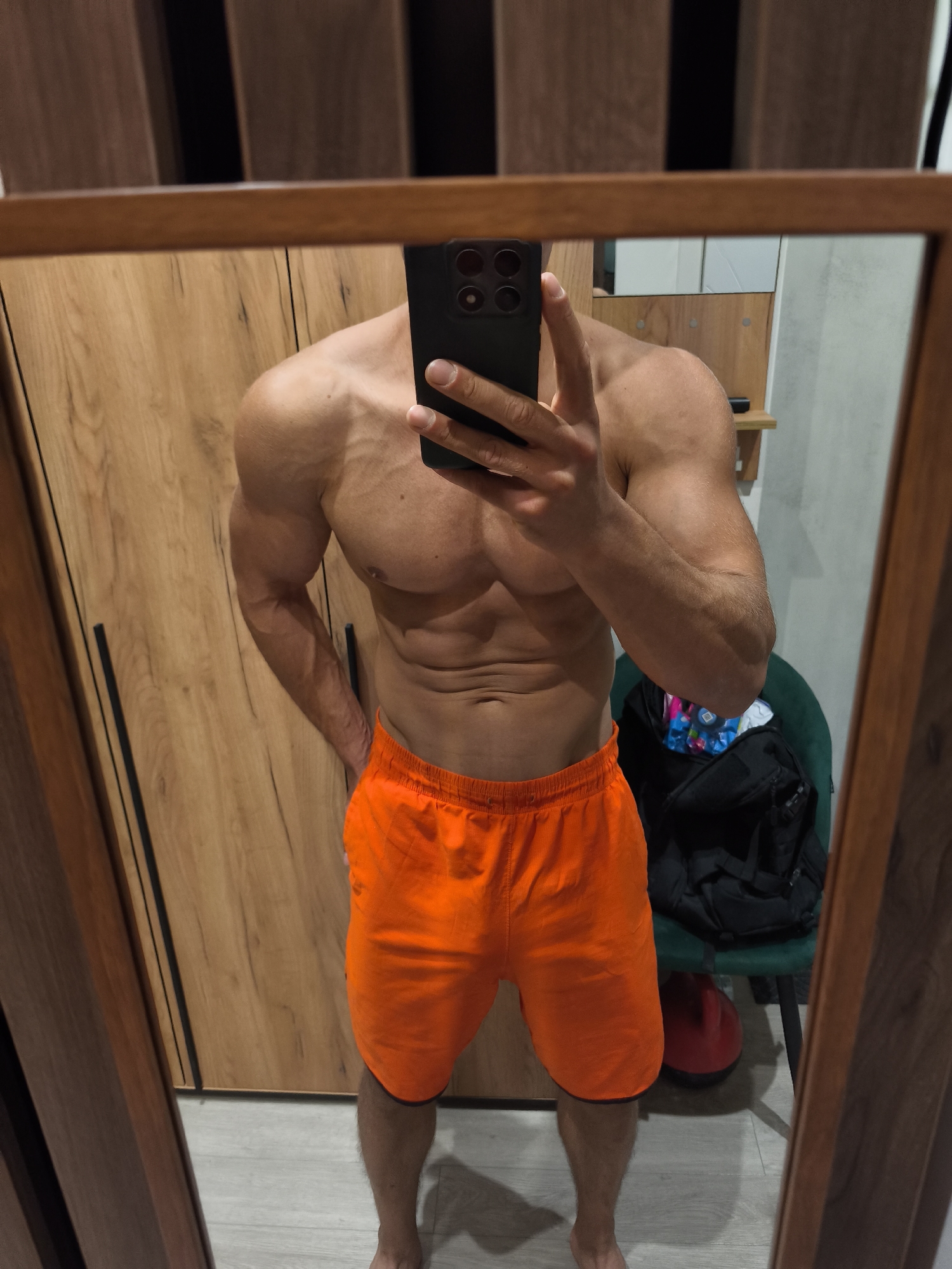 Shirtless man takes mirror selfie in Moscow bedroom