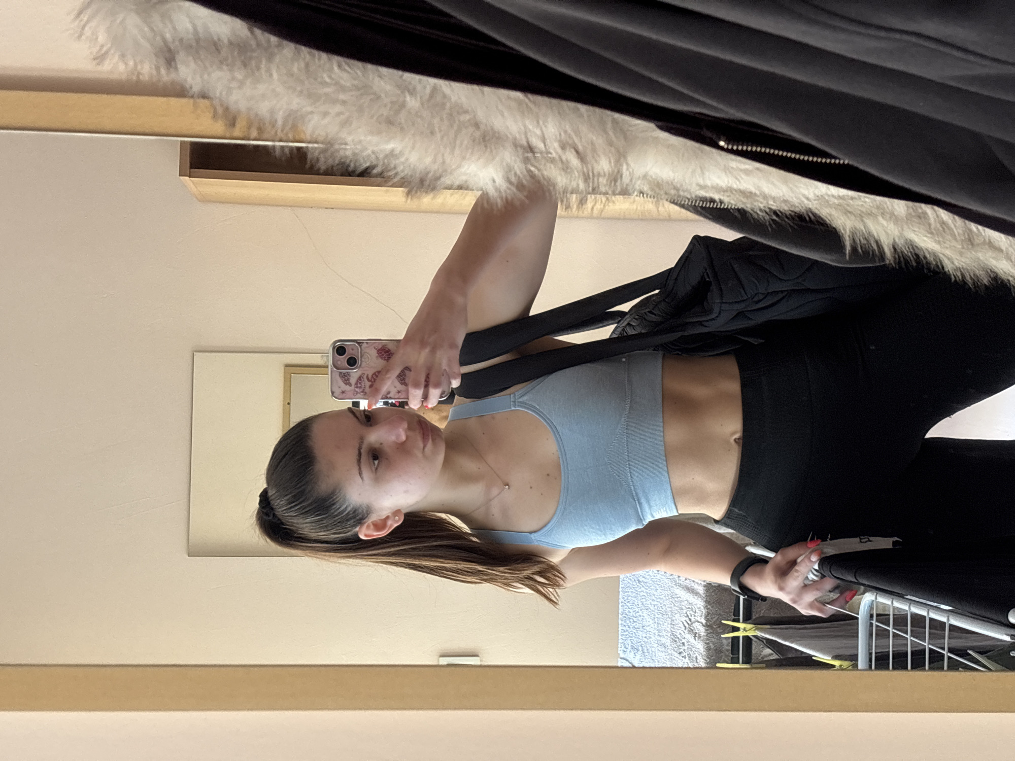 Young woman takes indoor mirror selfie, April 29