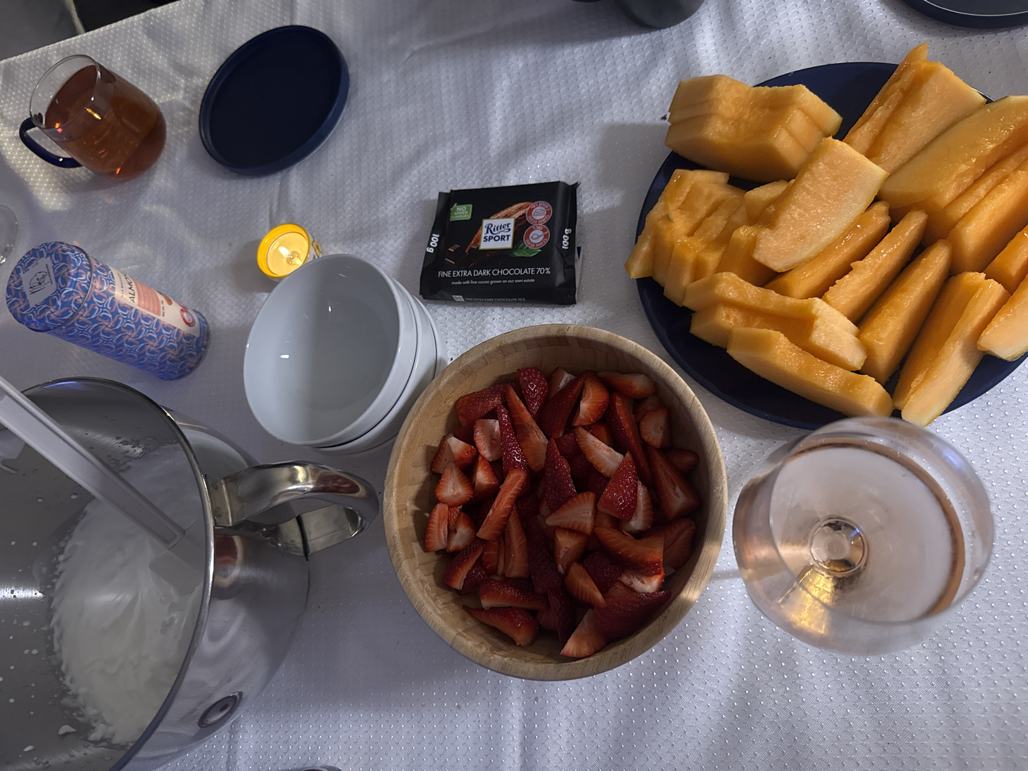 Elaborate meal with wine and desserts documented in Ariel