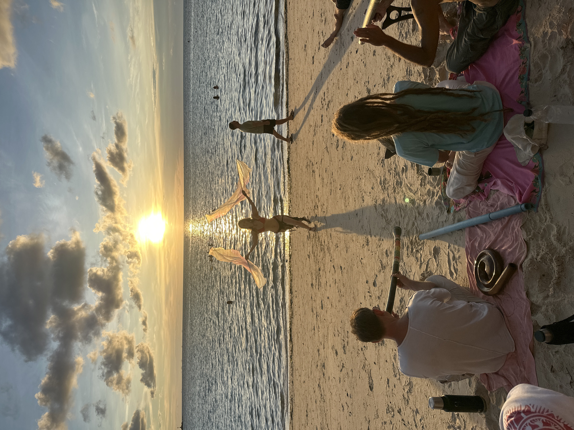Beachside sunset session with flags, music, and water on Koh Phangan