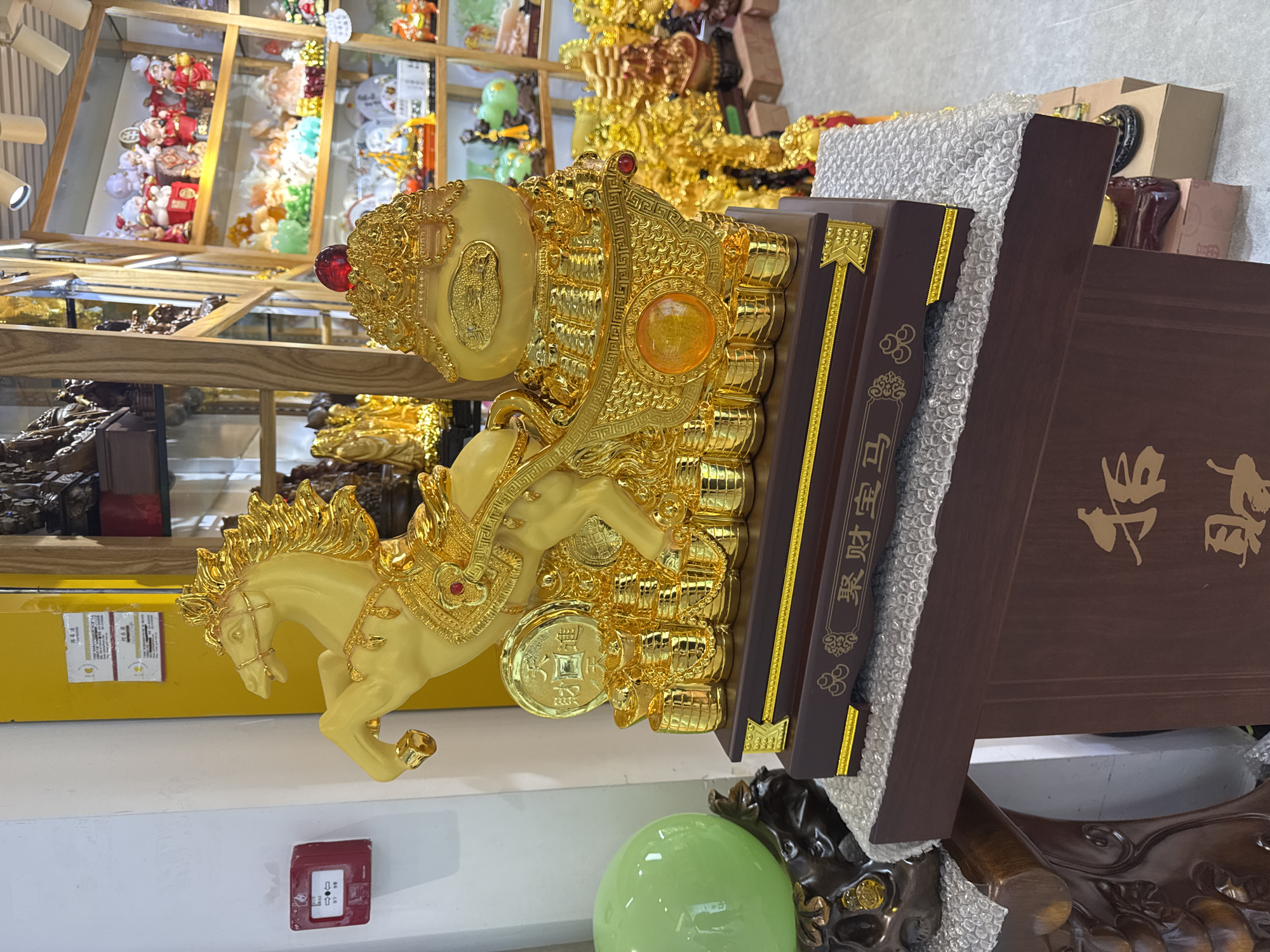 Golden horse statue displayed indoors in Yuexiu District