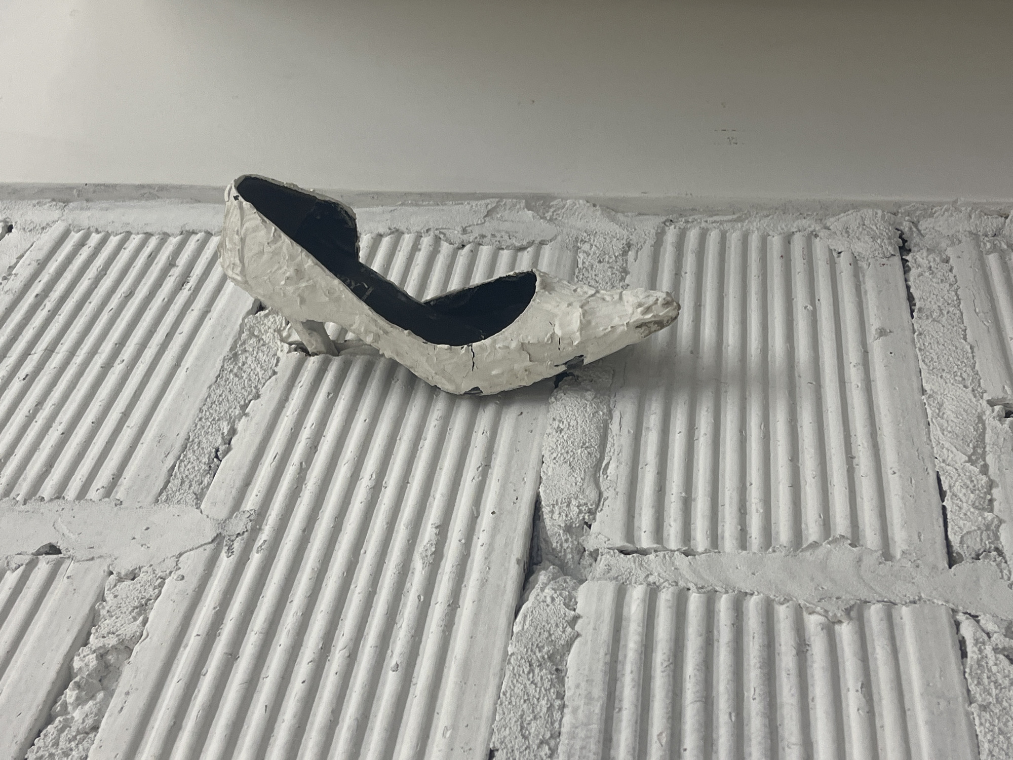 Objects observed against white brick surfaces in Buenos Aires