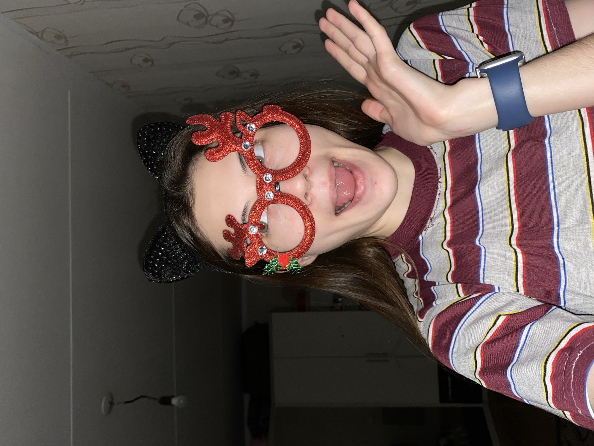 Young person takes playful selfies with novelty accessories in Votkinsk