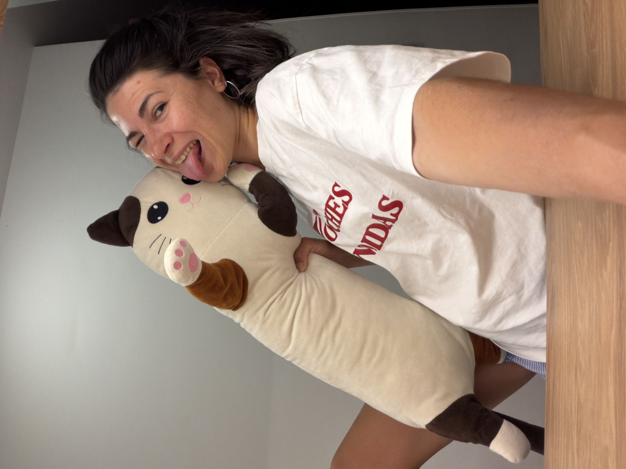 Woman poses with plush cat toy in Budva apartment