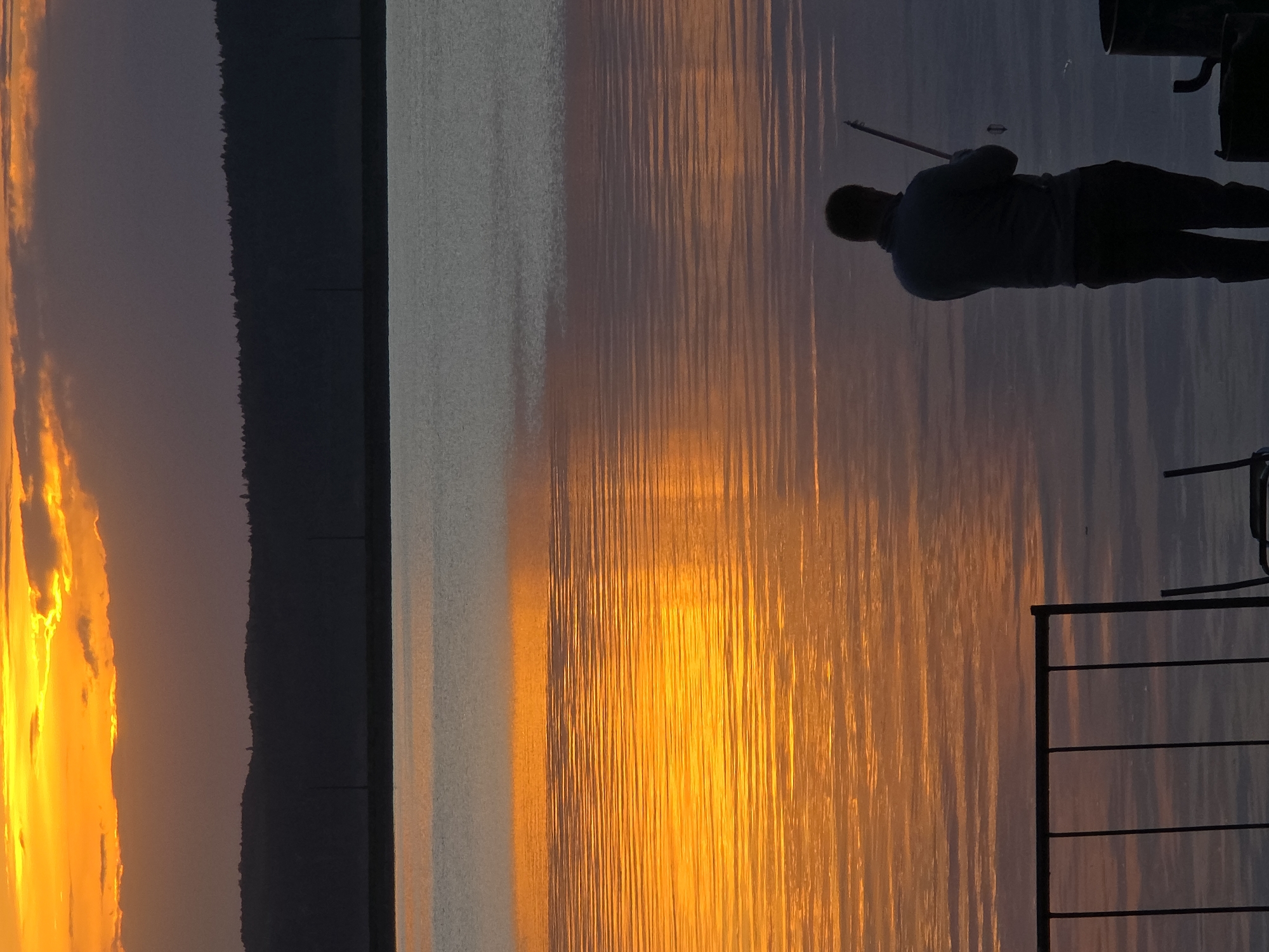 Sunset watchers gather along Chaikovsky waterfront during golden hour