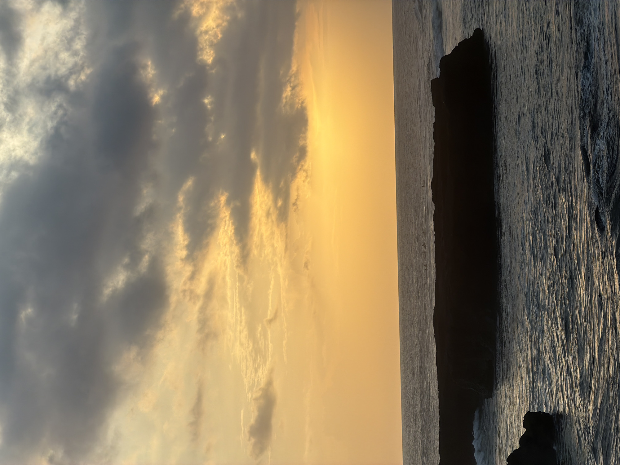 Sunset with orange-gold clouds observed in North Kuta, Indonesia