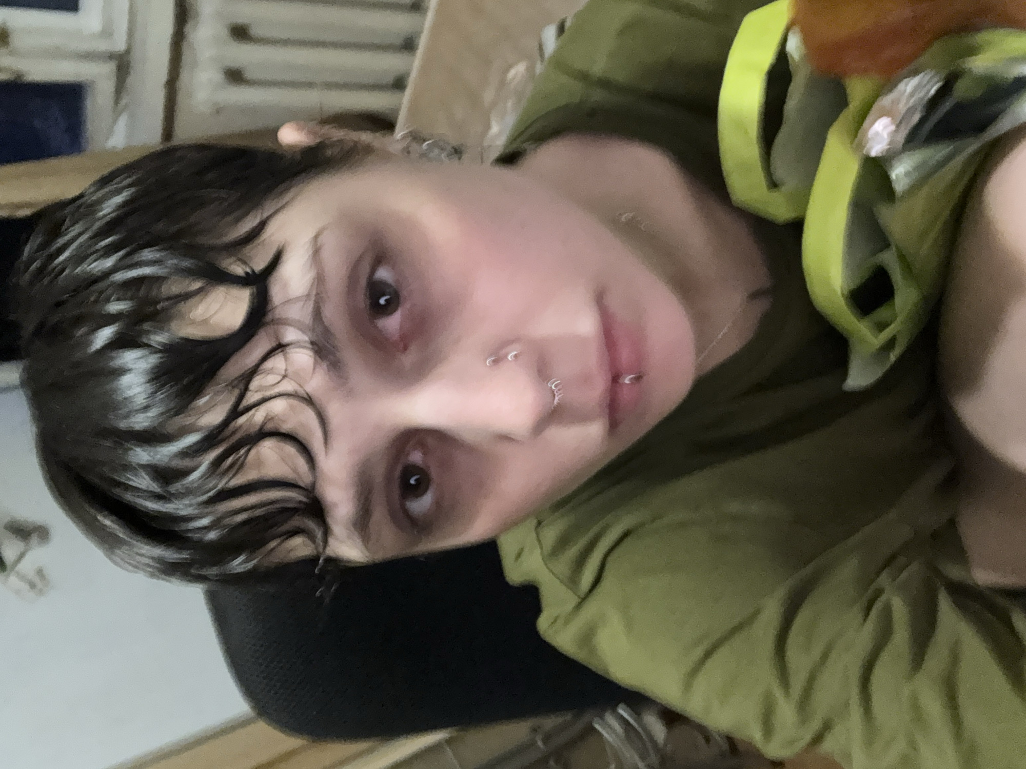Person with piercings takes selfie in Moscow