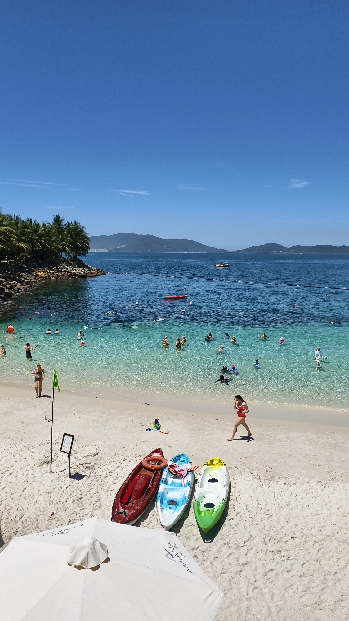 Beach resort visitors swim, relax in Nha Trang Bay