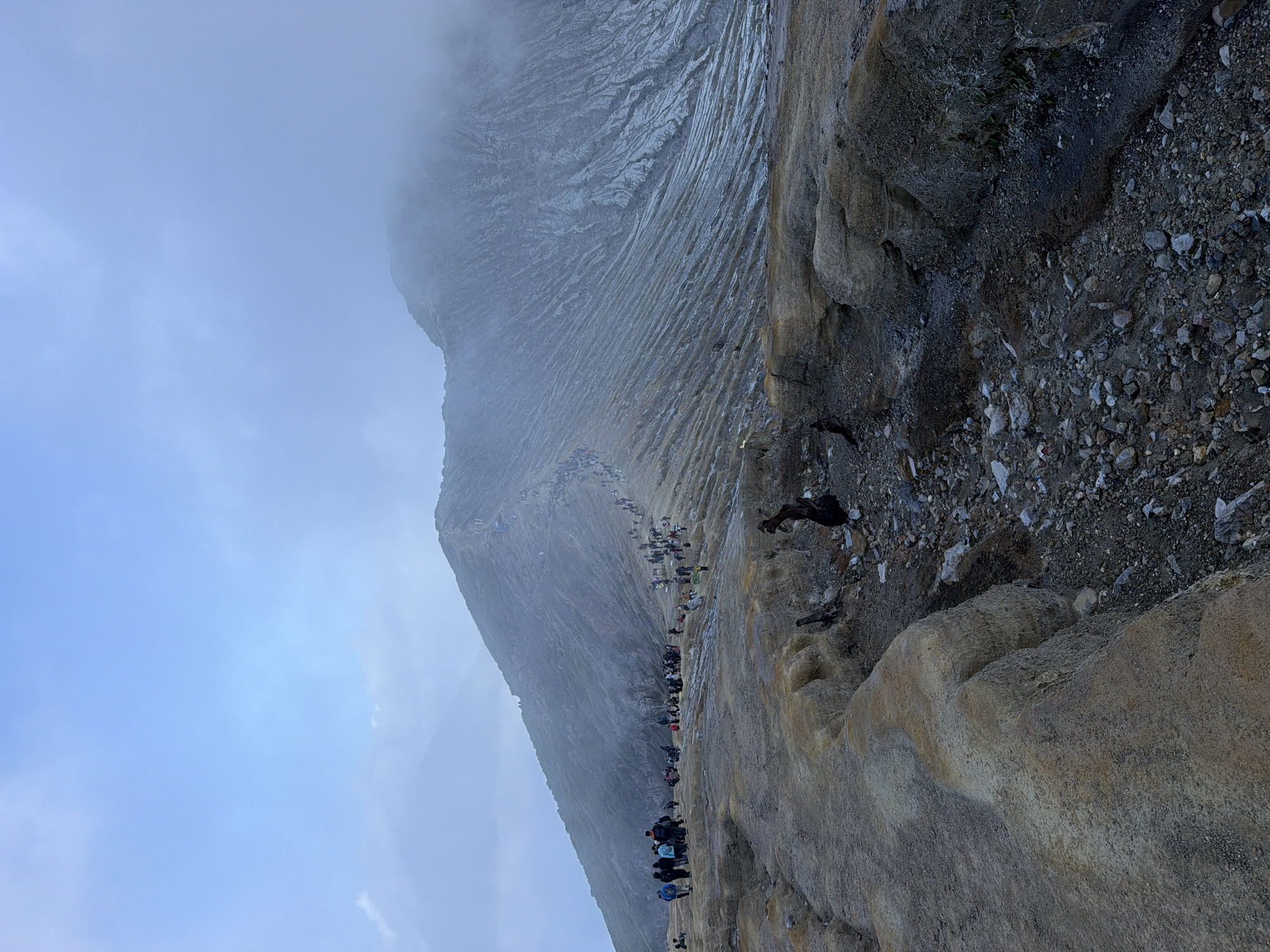 Tourists and sulfur vendors at Kawah Ijen crater, East Java