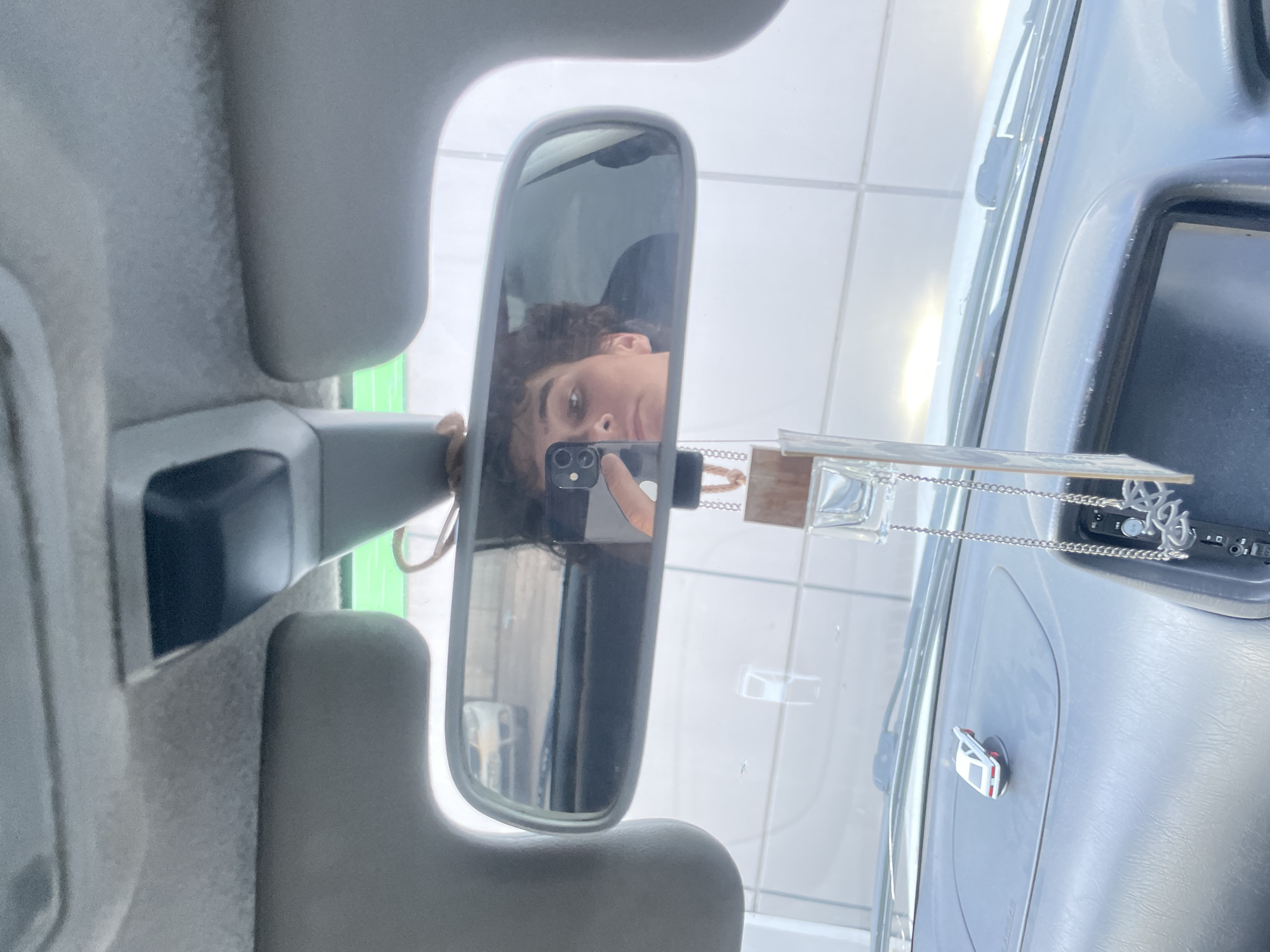 Rearview mirror selfie inside a car in Krasnoyarsk
