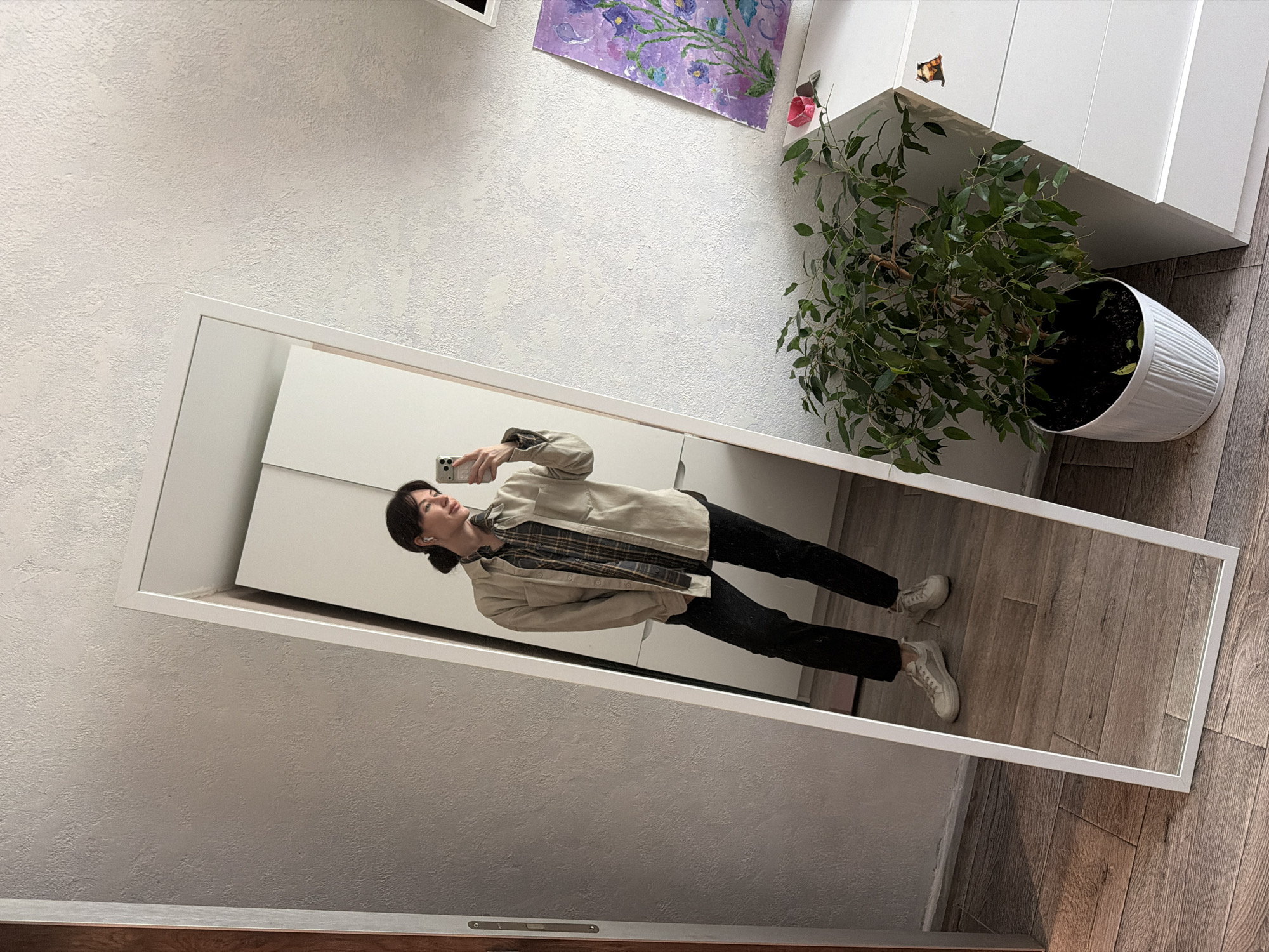 Woman takes morning mirror selfies in Perm apartment