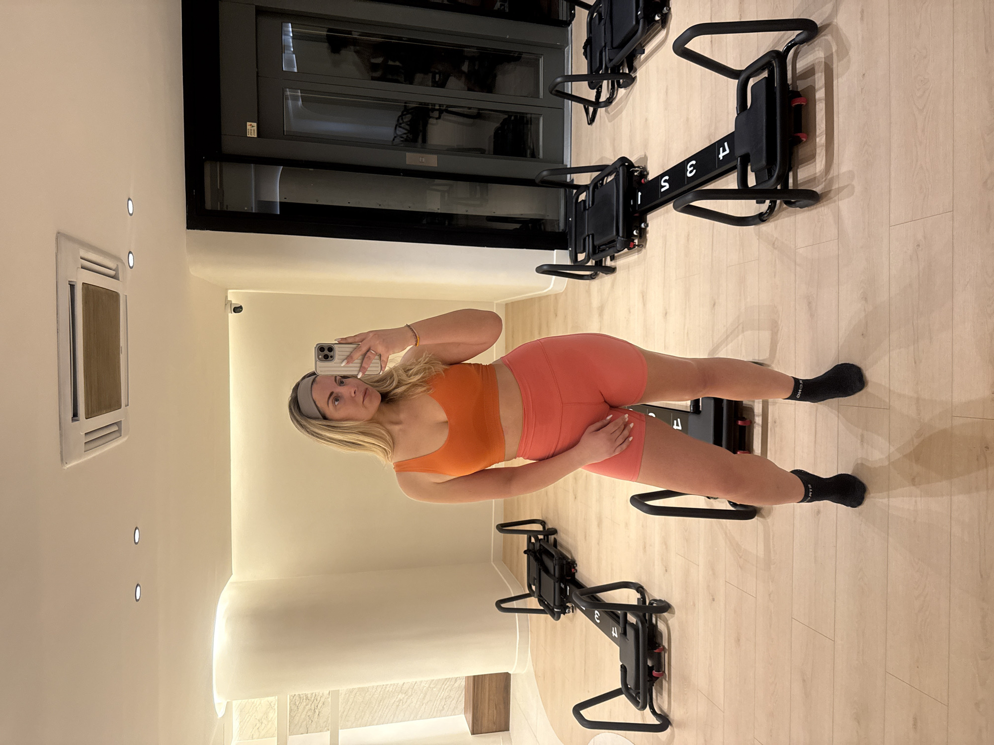 Woman takes mirror selfie at Paris fitness studio