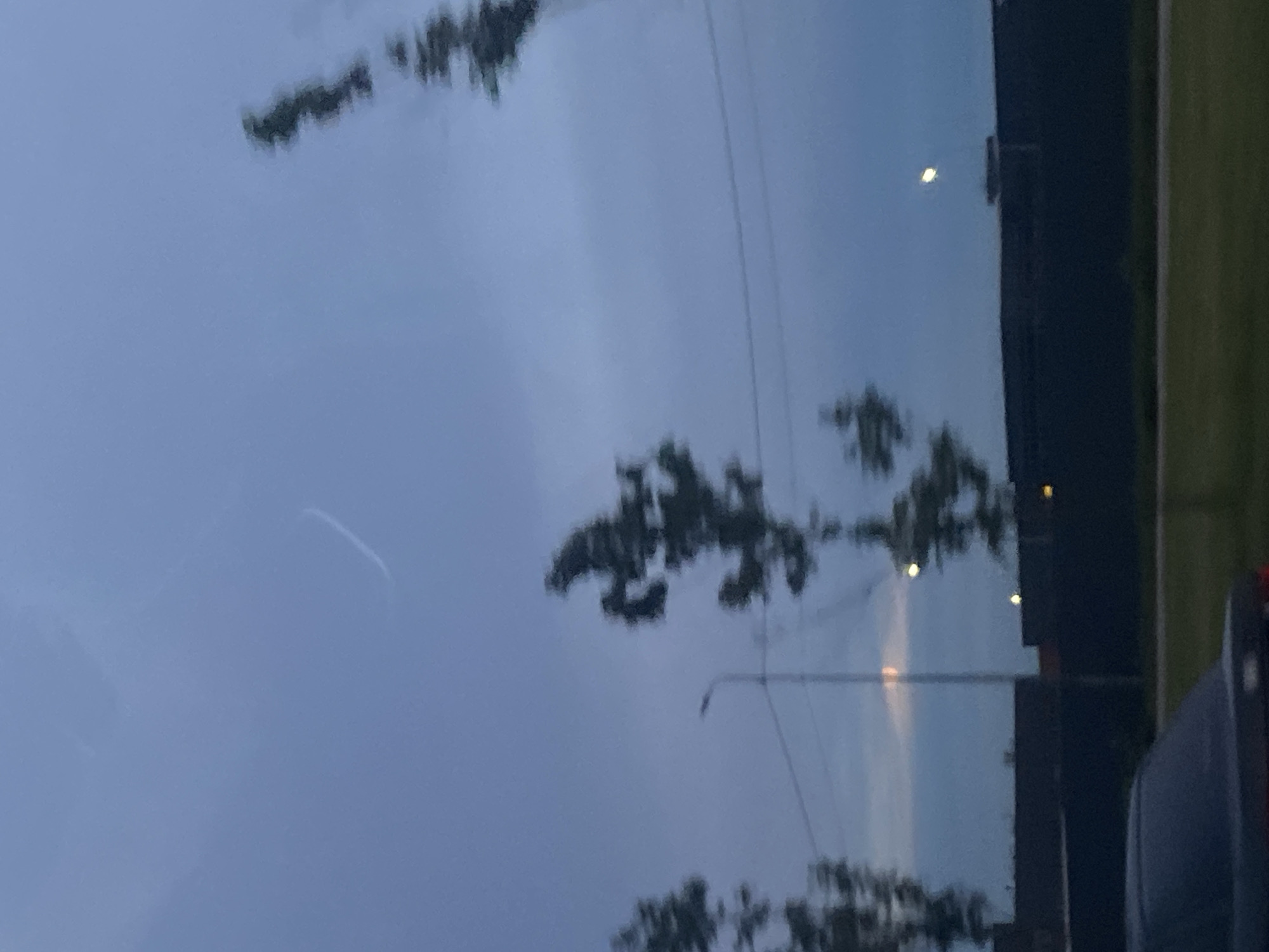 Road trip views through hazy skies and tree-lined landscape