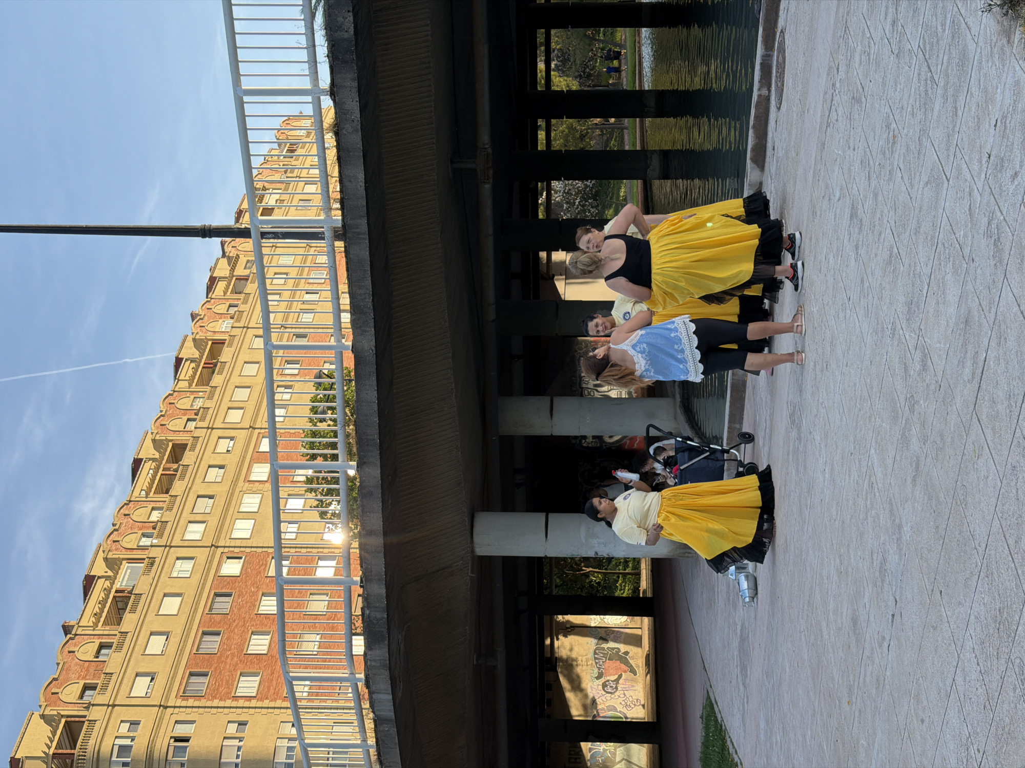Traditional folk dancers perform with containers across Valencia parks