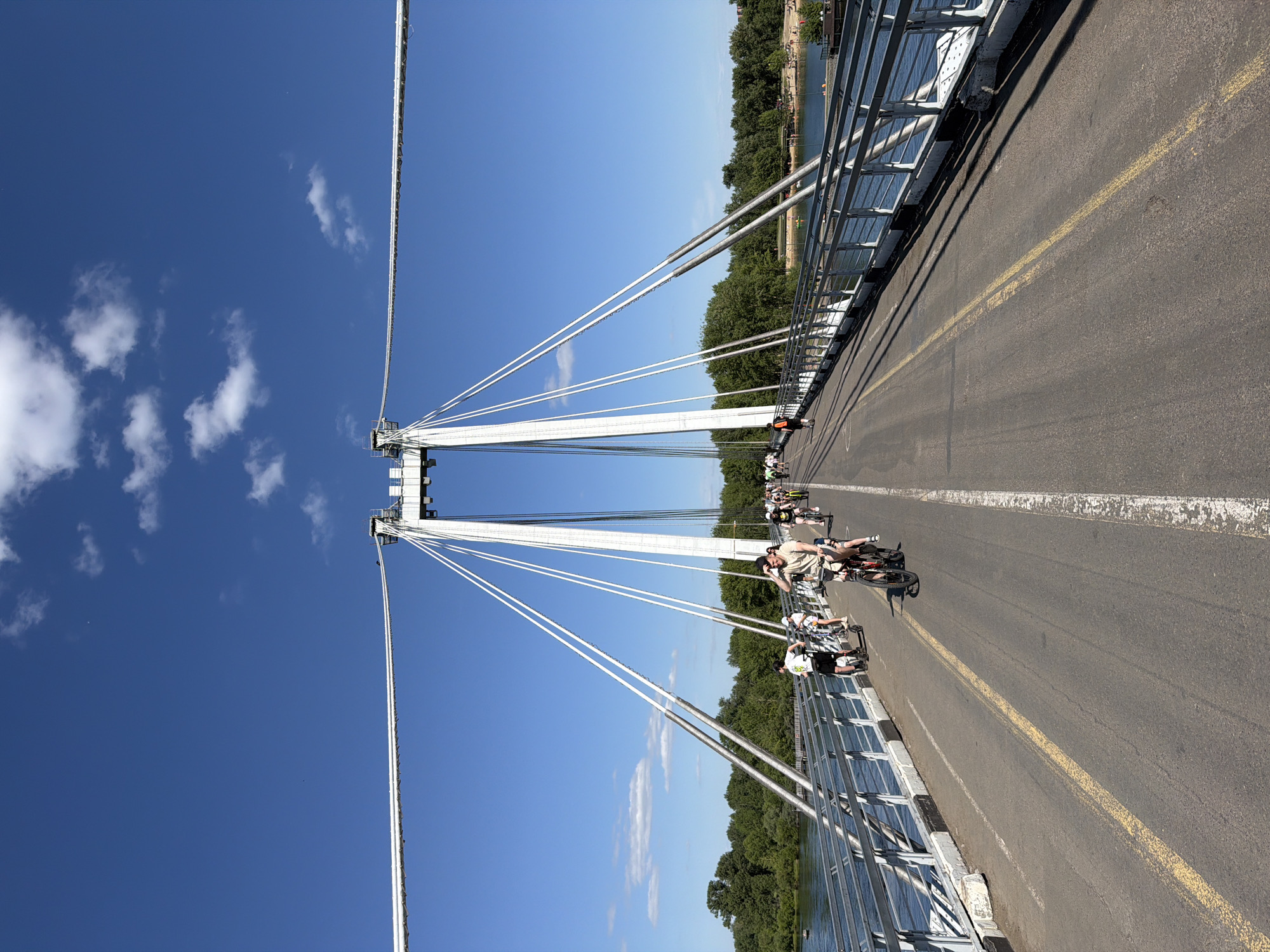 Morning activity along Krasnoyarsk's Strelka Bridge and riverside park