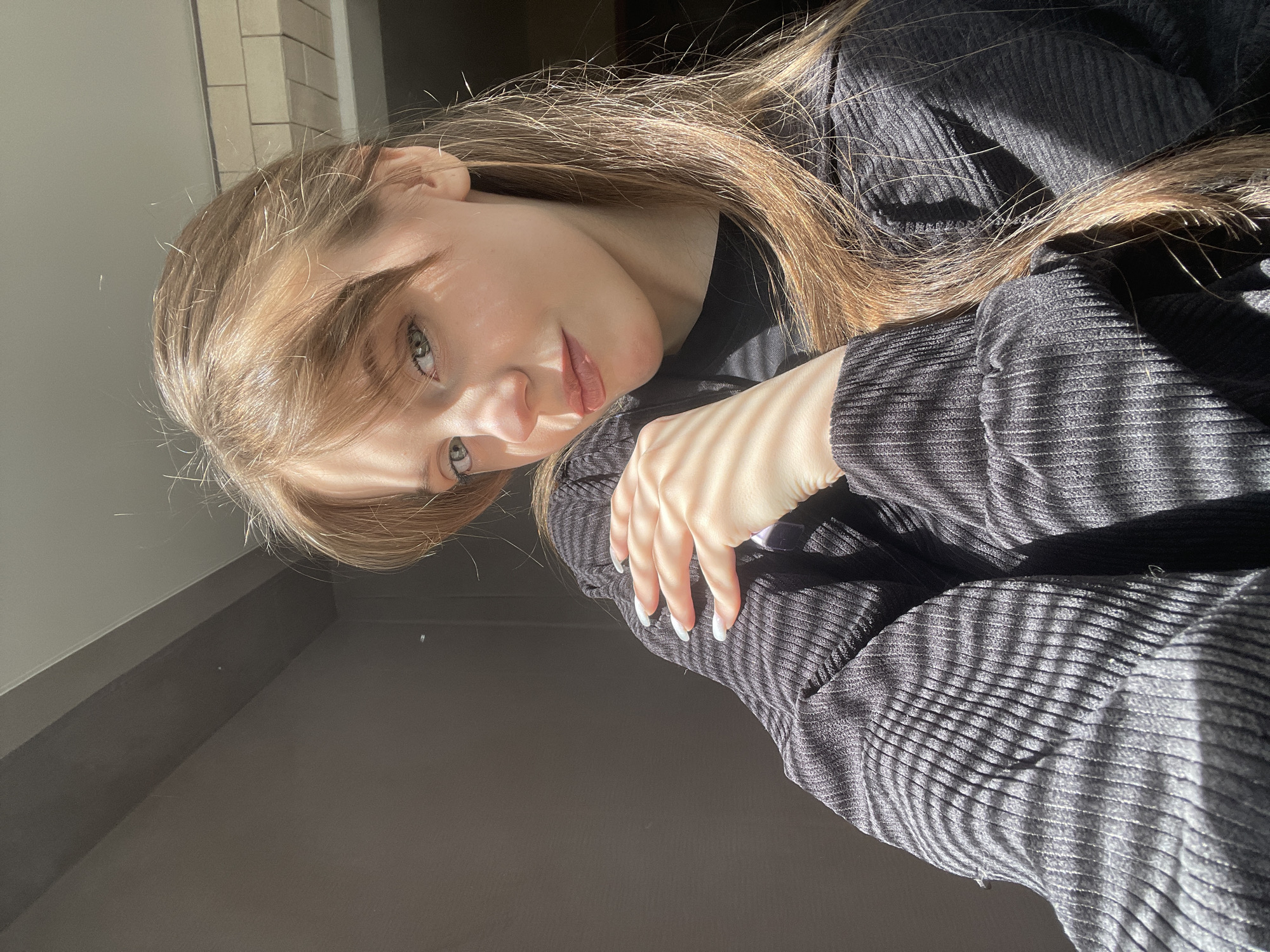 Woman in black clothing observed in indoor setting