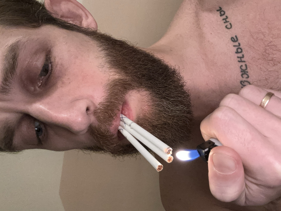 Bearded man photographed smoking, holding cat in Saint Petersburg apartment