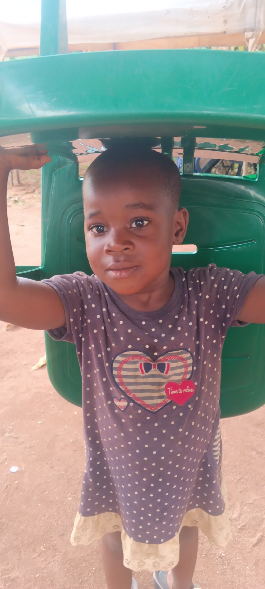 Children play soccer and dance outdoors in Eziudo, Nigeria
