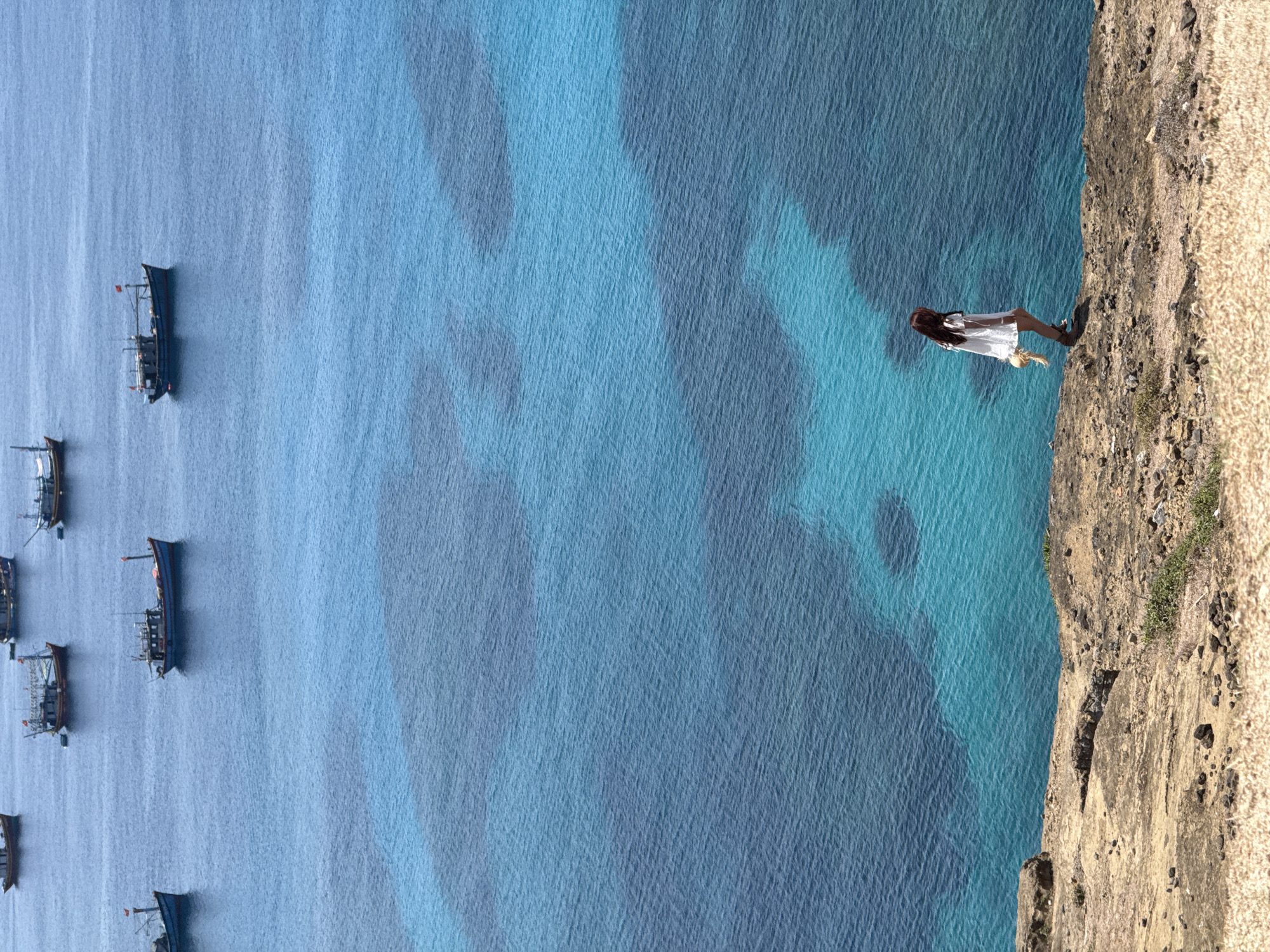 Clifftop views and fishing boats off Lý Sơn Island, Vietnam