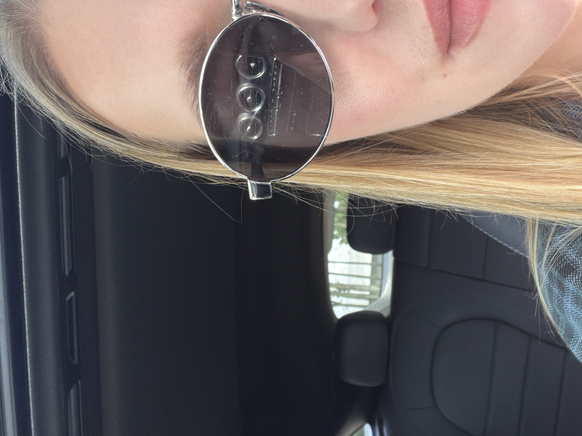 Sunglasses selfie inside a parked car in Riga