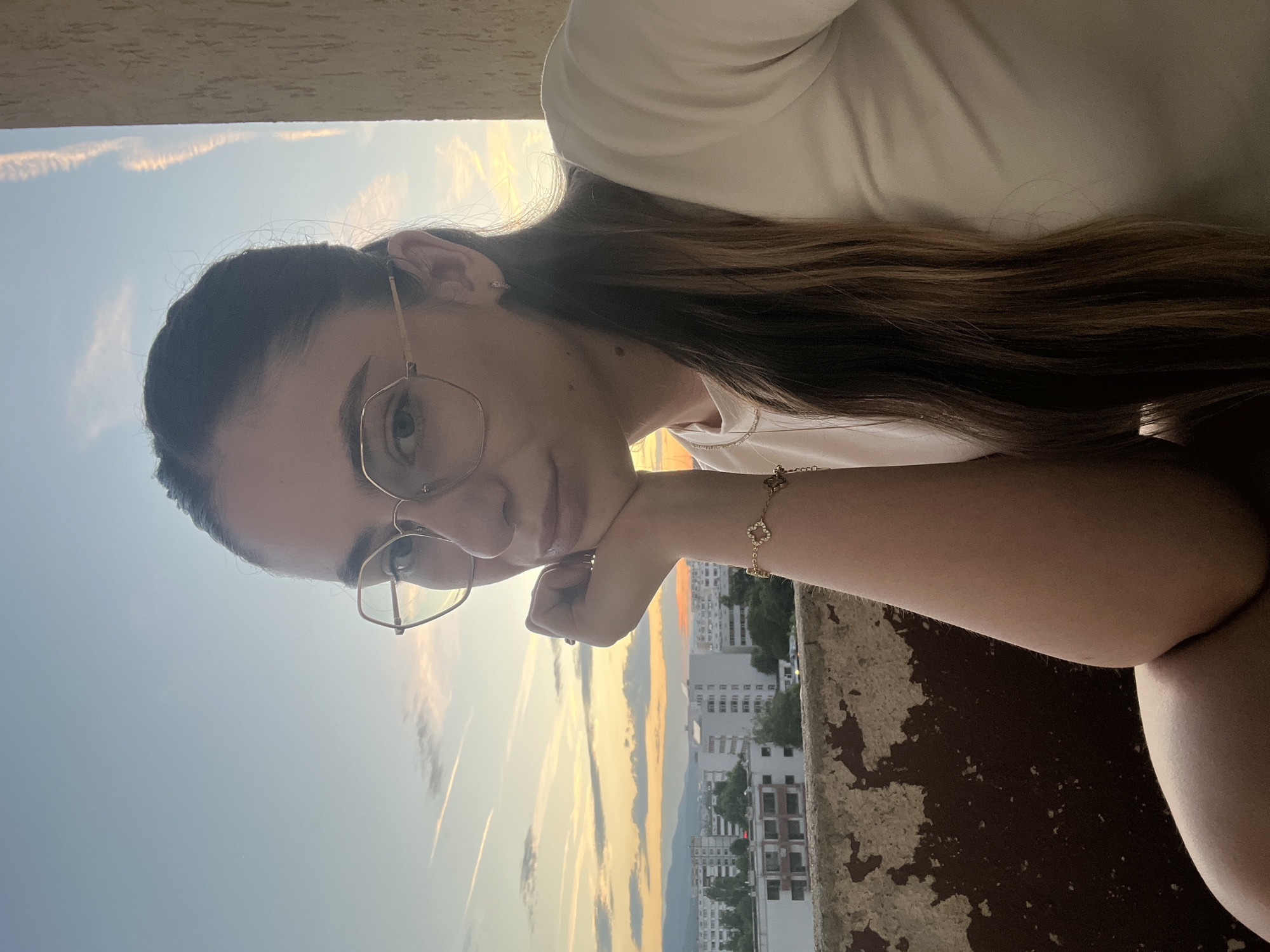 Balcony selfie session at golden hour overlooking the city