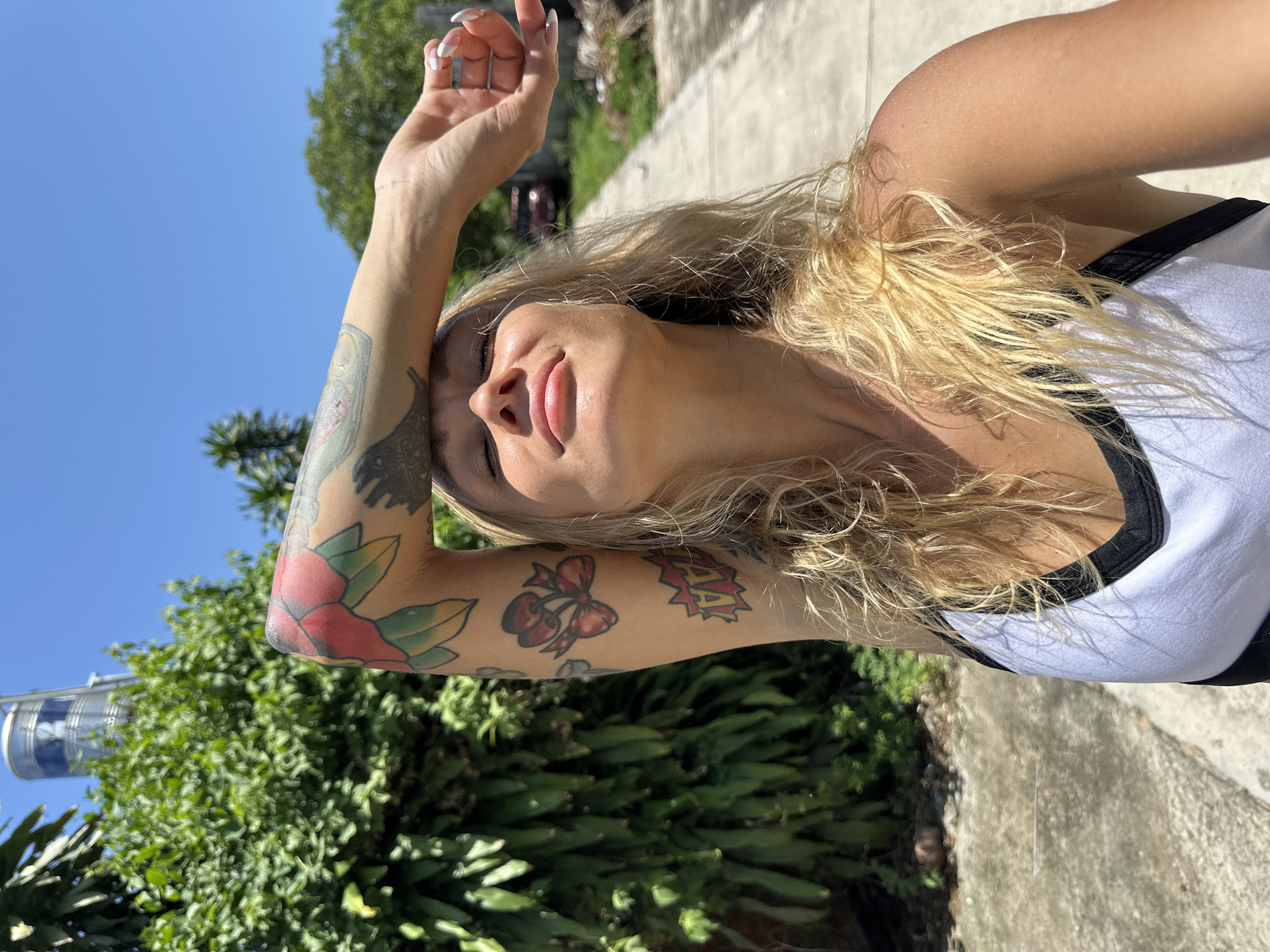 Tattooed blonde woman photographed multiple times in Mũi Né