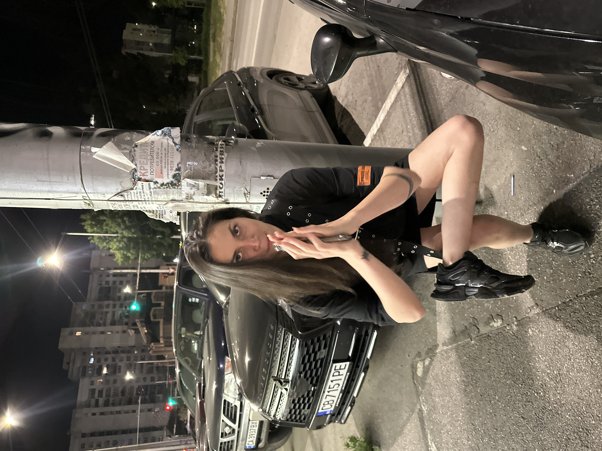 Young people document nighttime city outing with selfies, landmarks