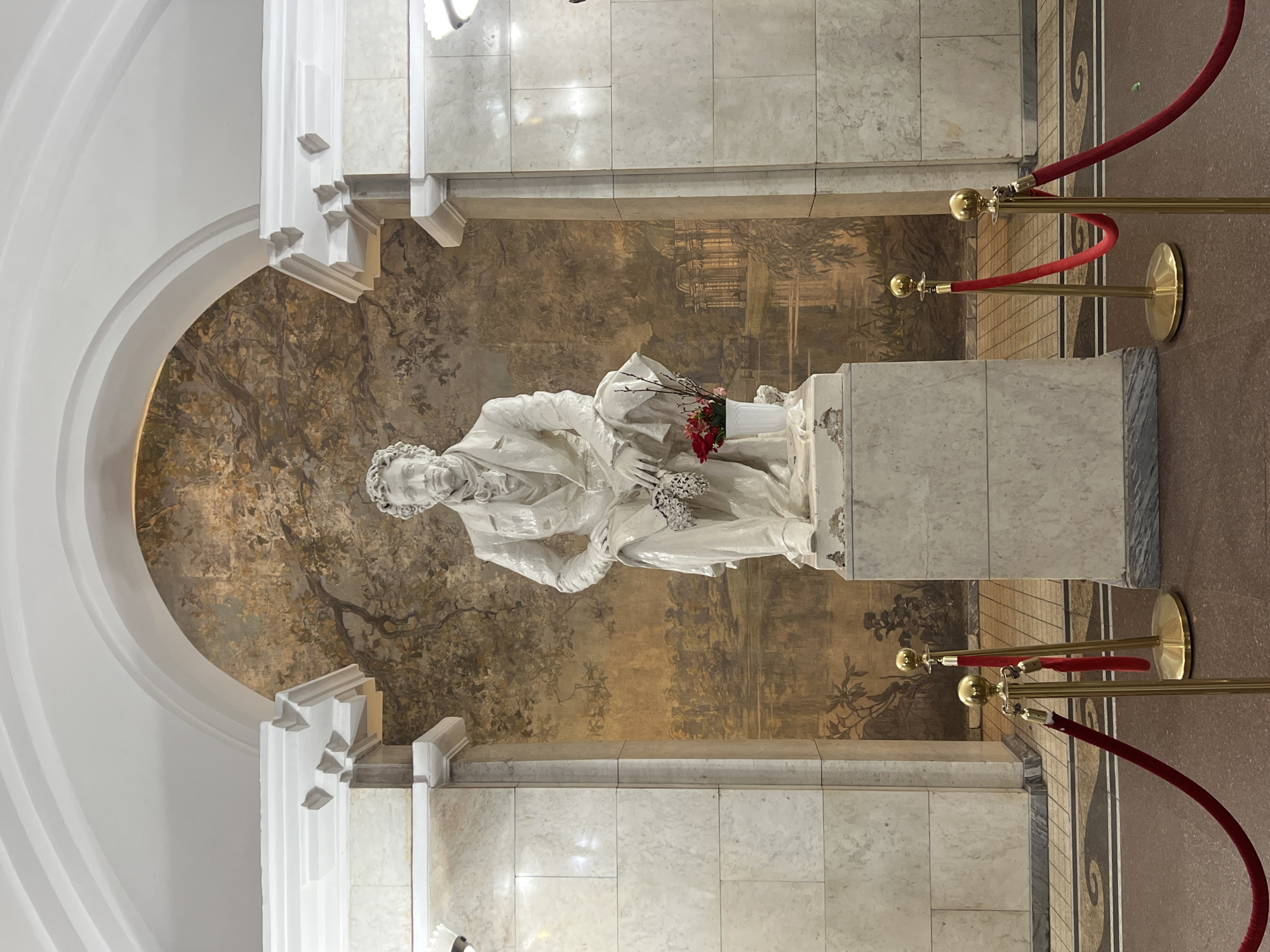 Pushkin statue observed with landscape mural backdrop in Saint Petersburg