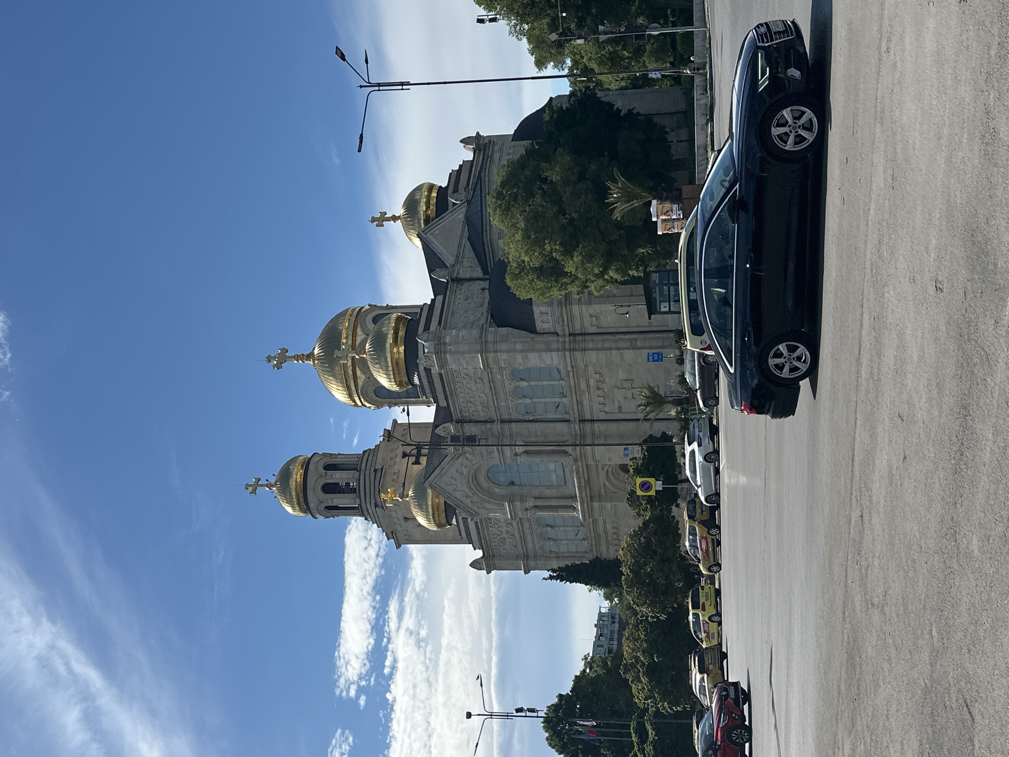 Driving past a golden-domed cathedral on an afternoon trip