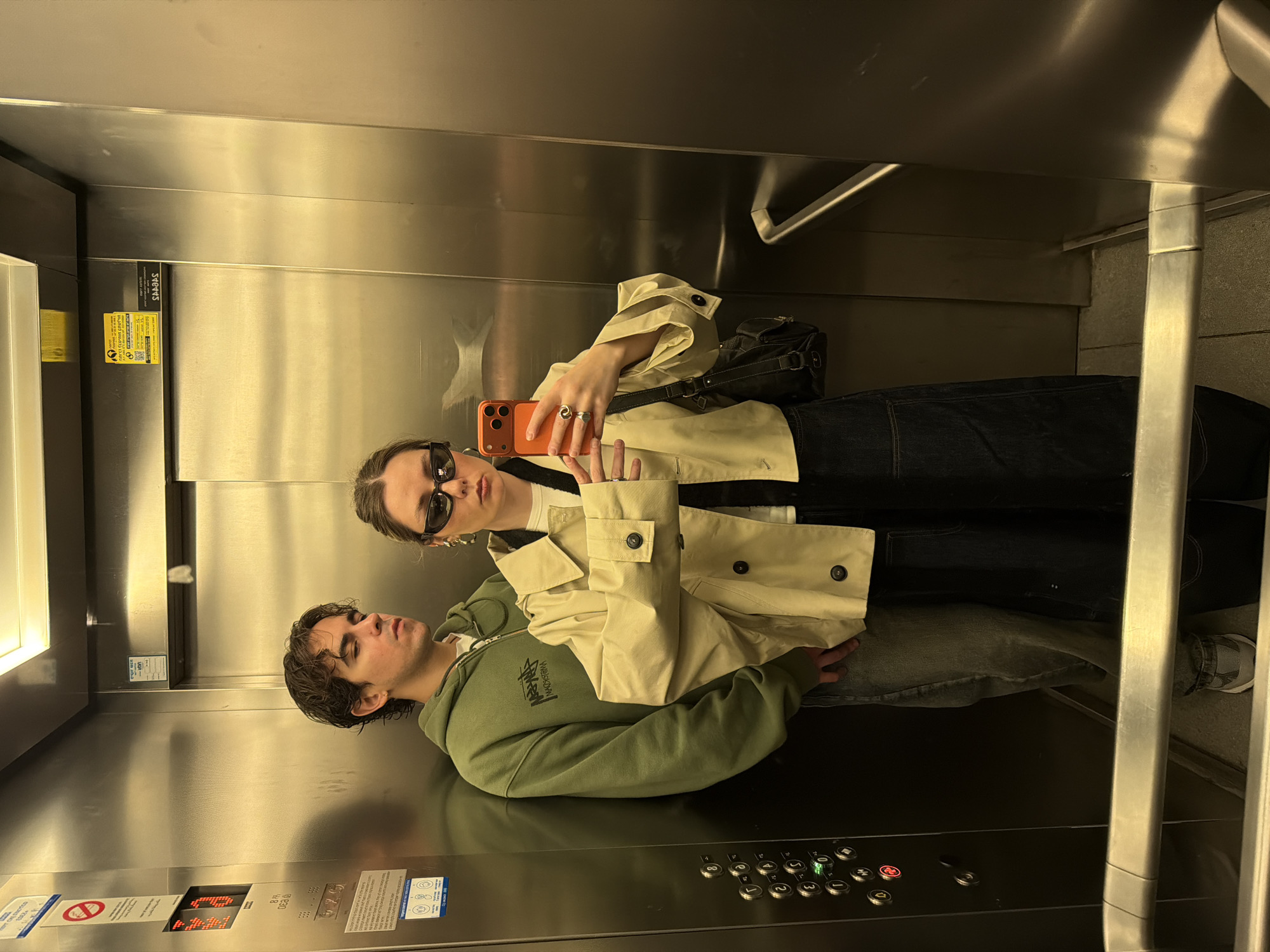 Two people ride elevator in Tel Aviv building