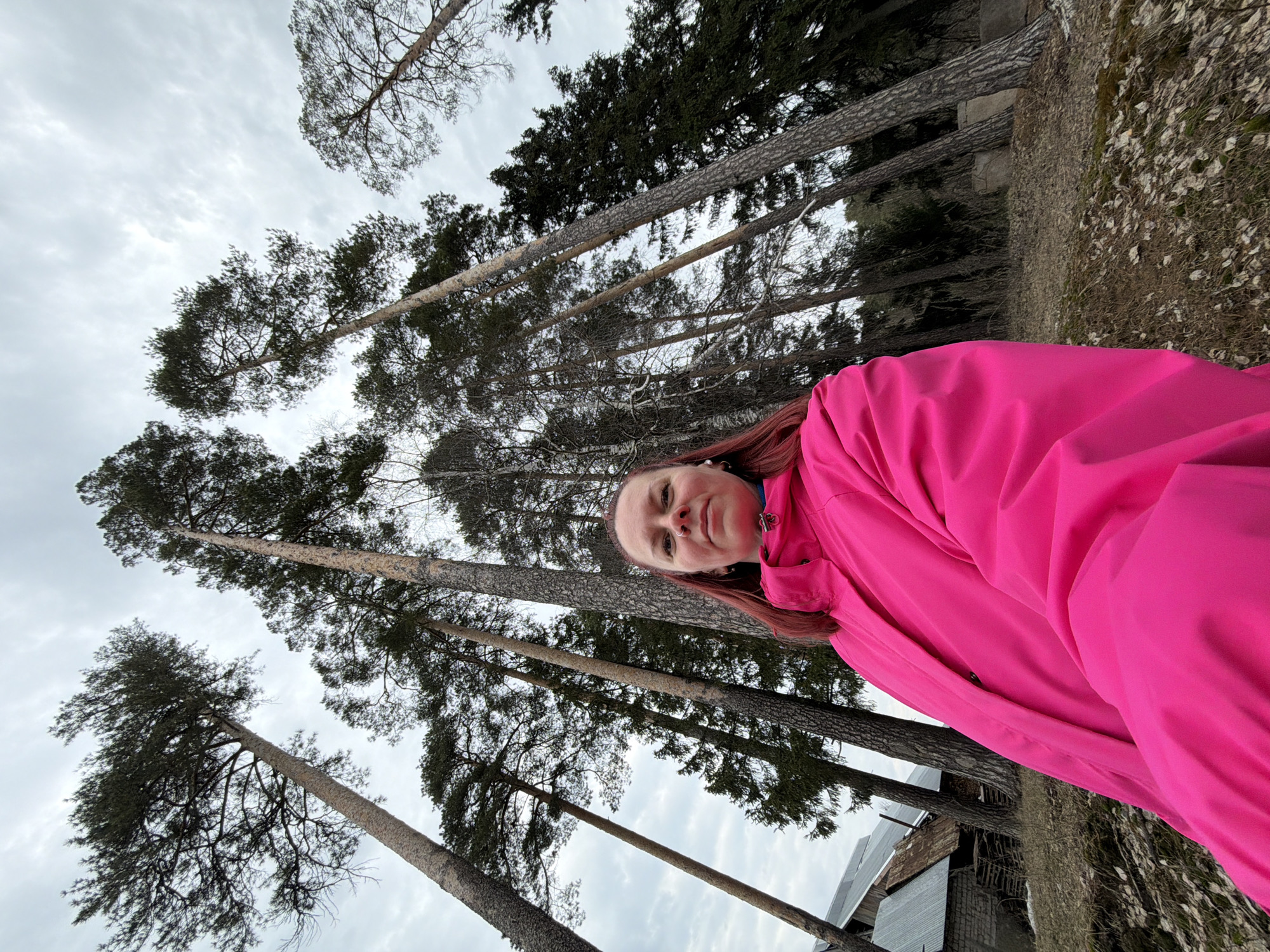 Woman takes forest selfies during cloudy afternoon walk in Chaikovsky