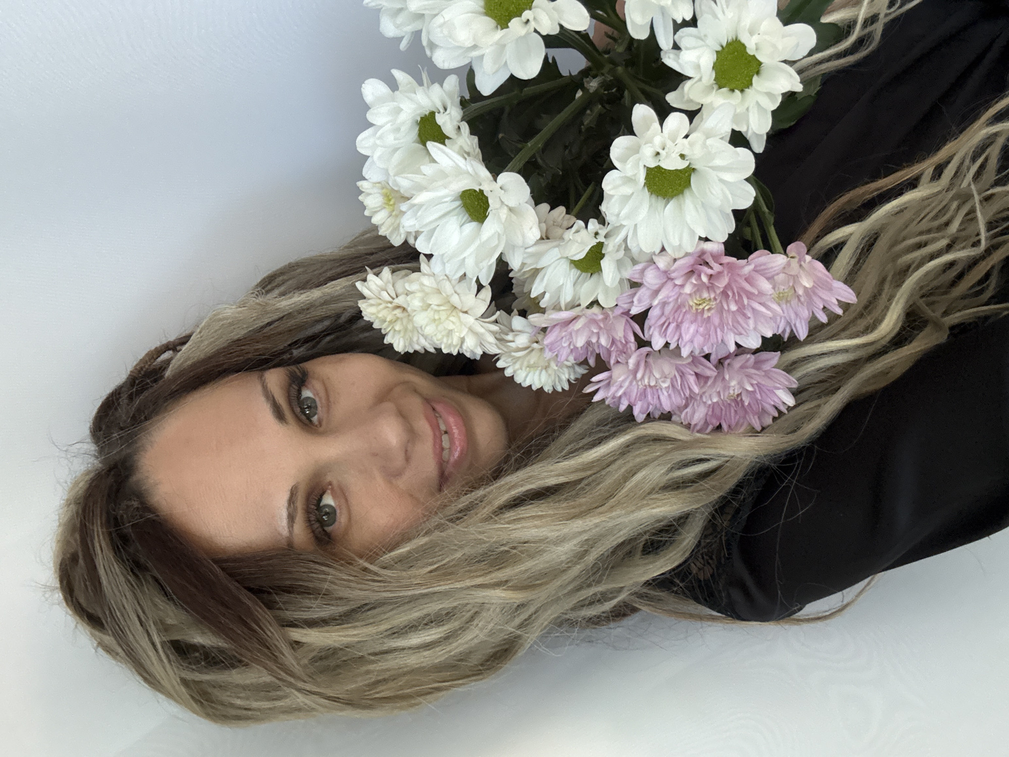 Selfie session with chrysanthemums in a black satin robe