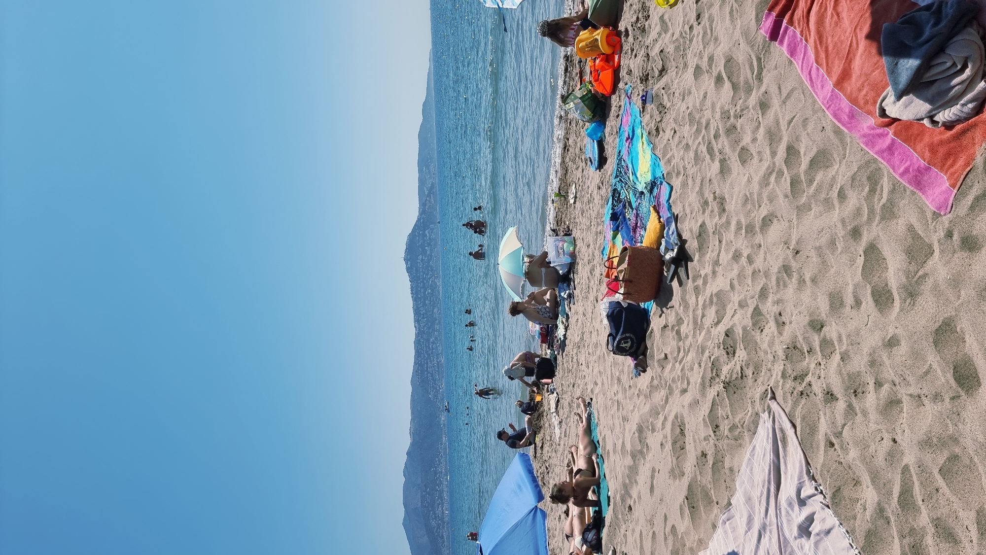 Busy summer morning at Empuriabrava beach, parasailing included