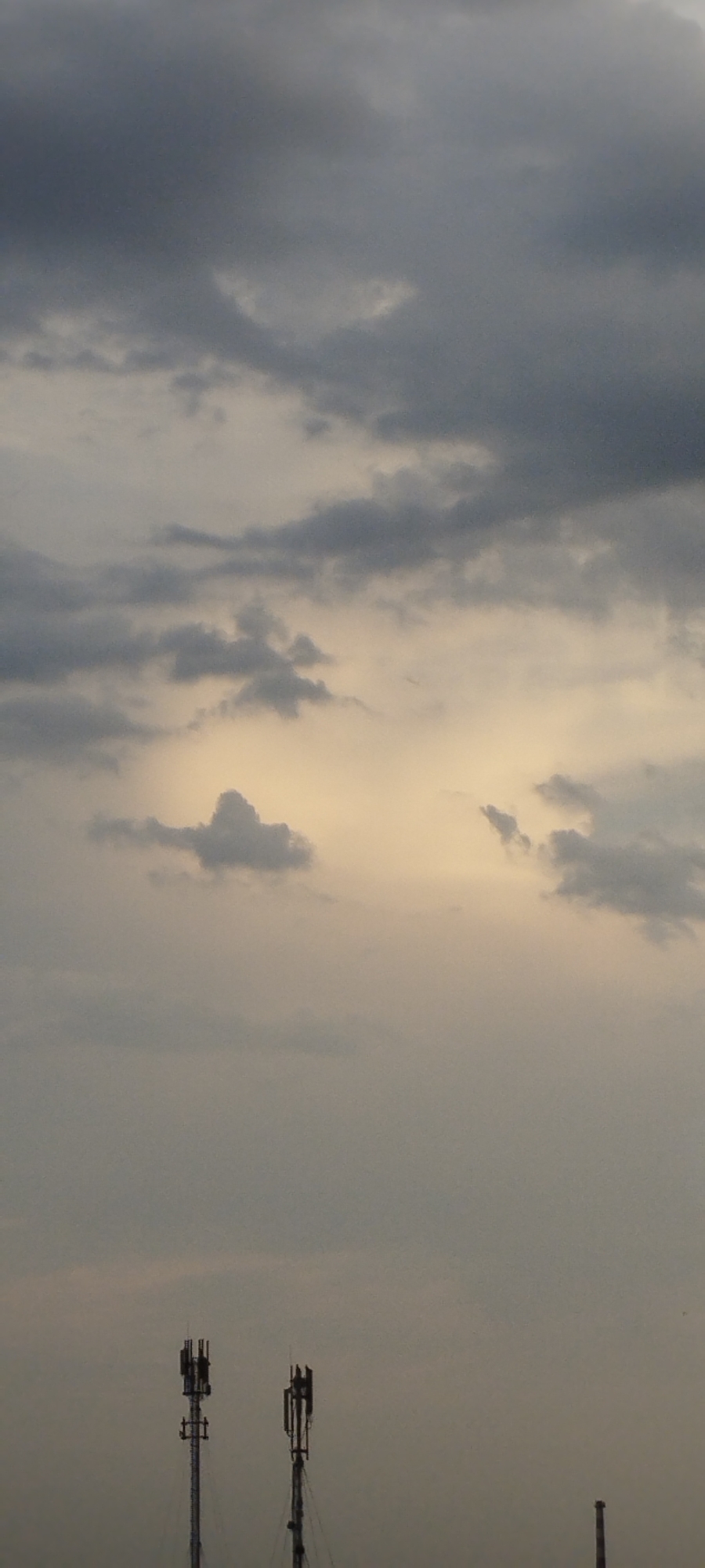 Storm clouds gather over city rooftops, with fresh produce close-ups