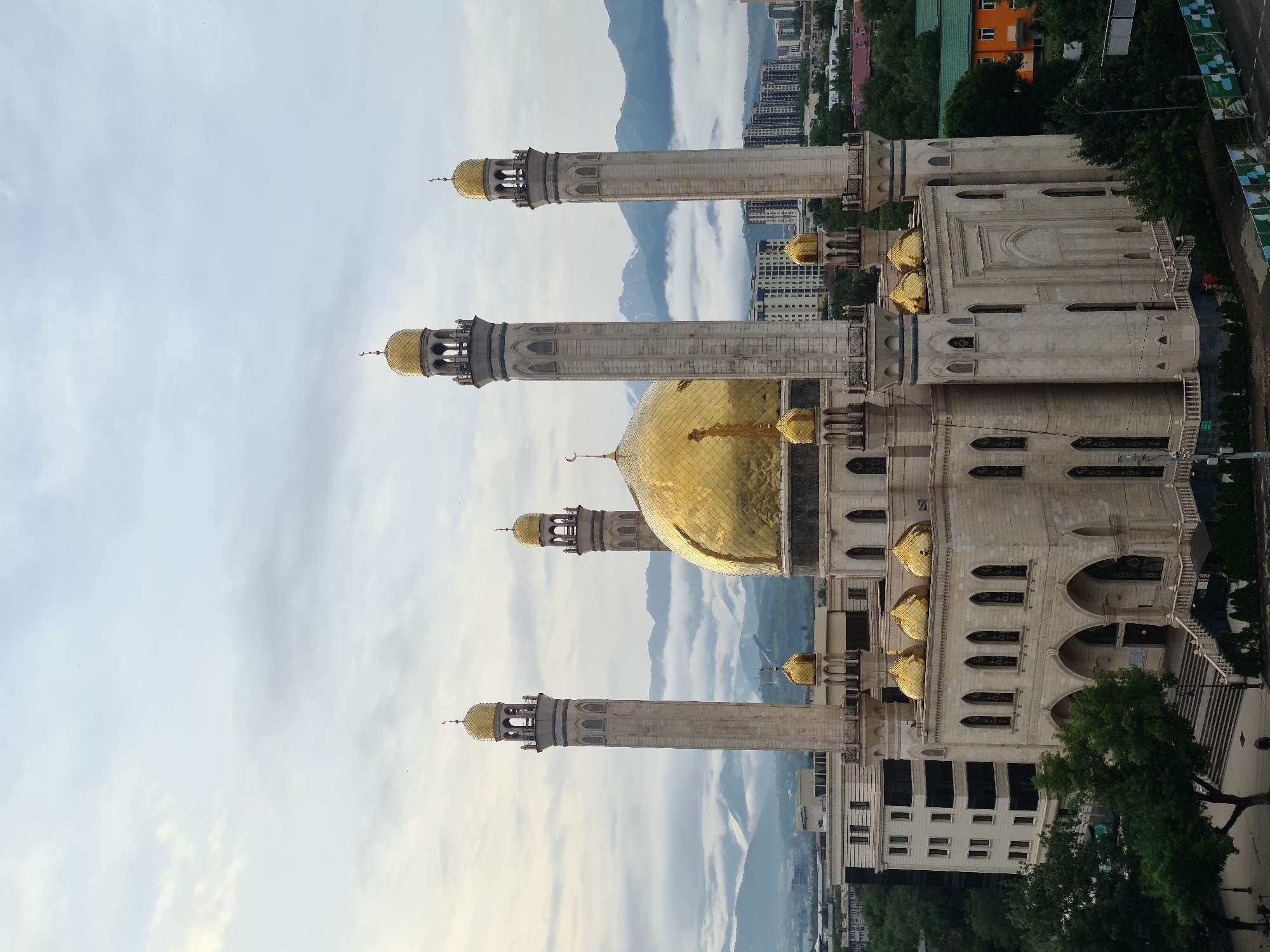 Almaty's Central Mosque seen from multiple angles under cloudy skies