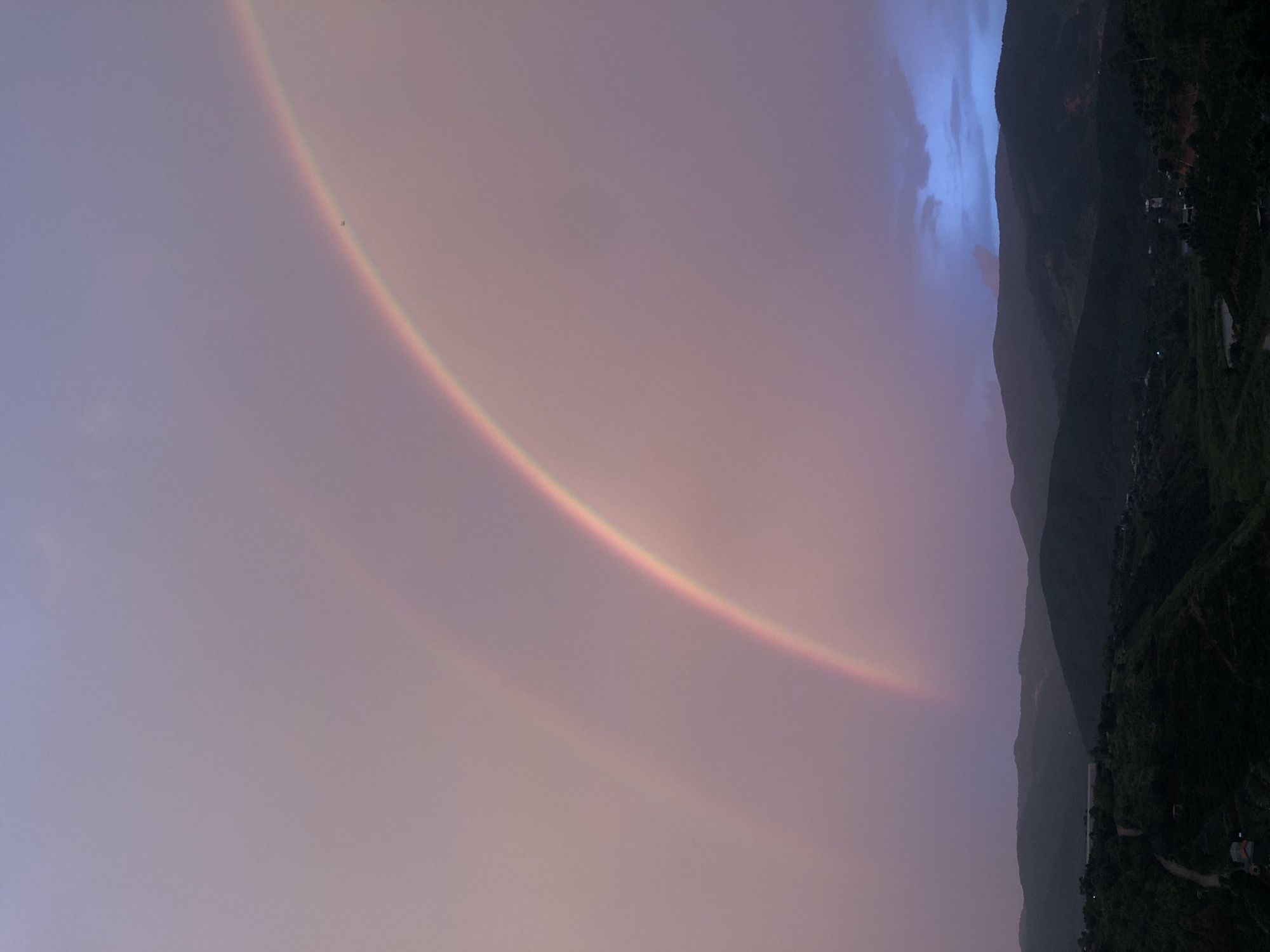 Double rainbow lights up dusk sky over Thôn 3 hills