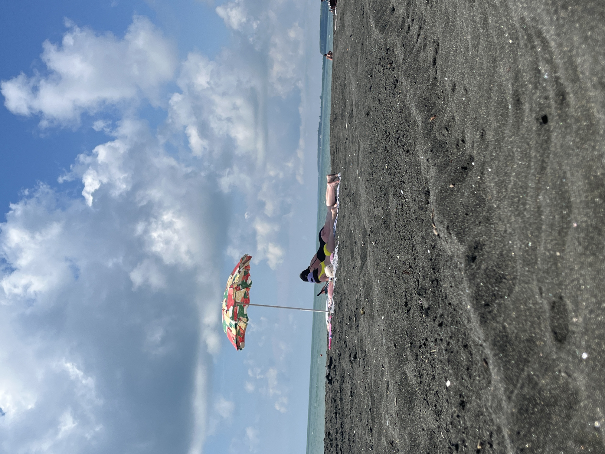 A lazy morning on Ureki's black sand beach
