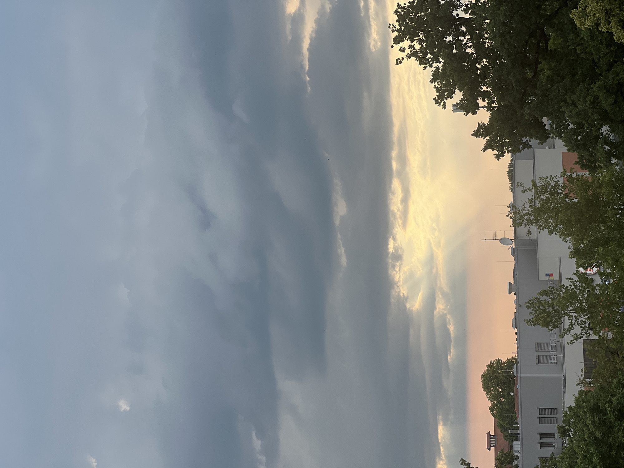 Rooftop views and cloudy skies over Straubing on a summer afternoon