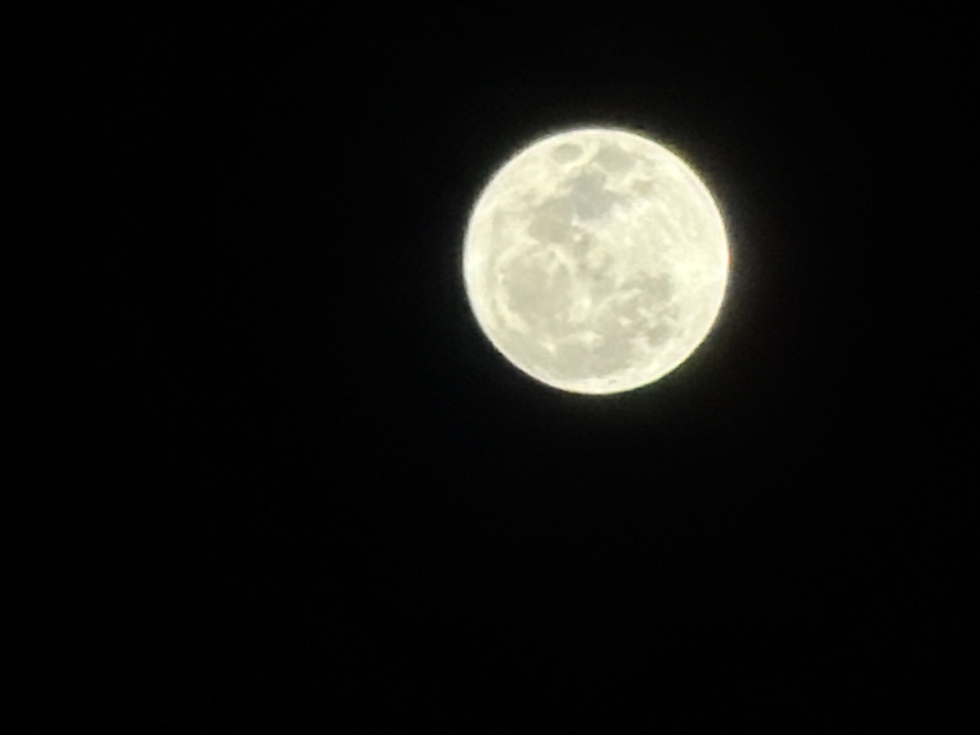 A night out in Burgas: full moon, lit streets, restaurant glow.