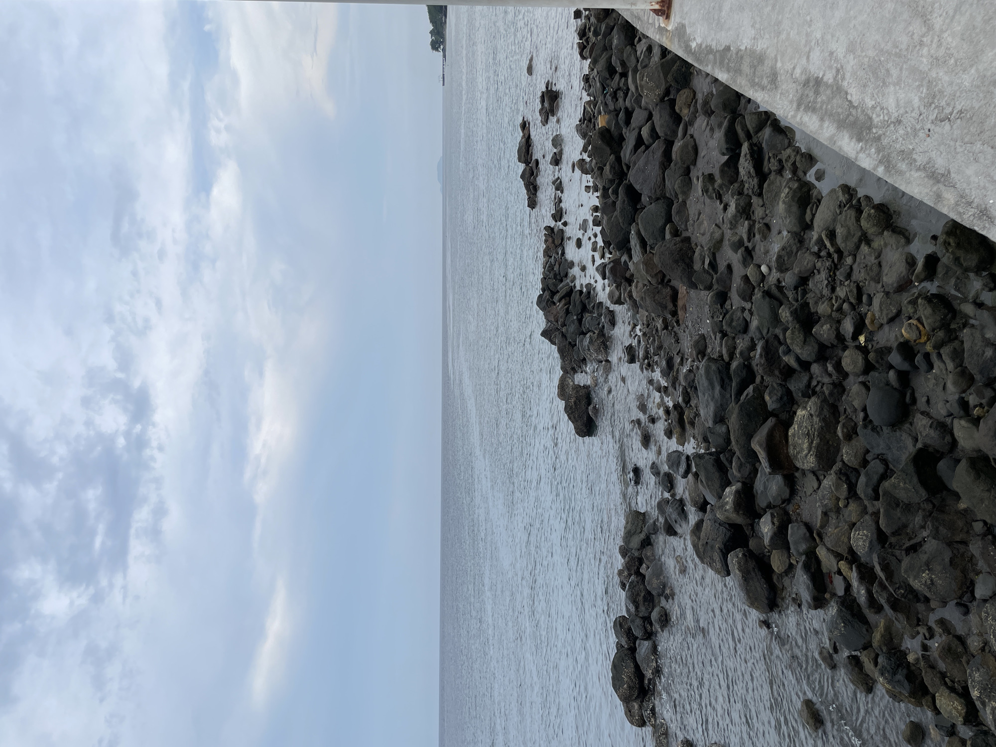 Morning coastal views captured along Bacong seawall under cloudy skies