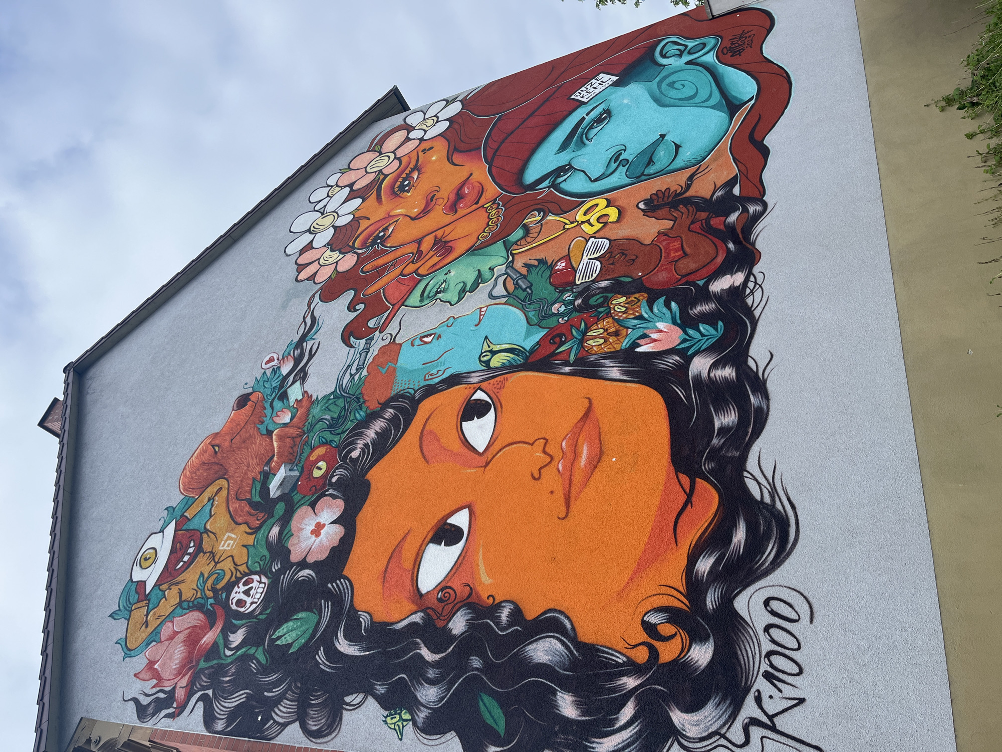 Vibrant street mural with stylized faces spotted in Kehl