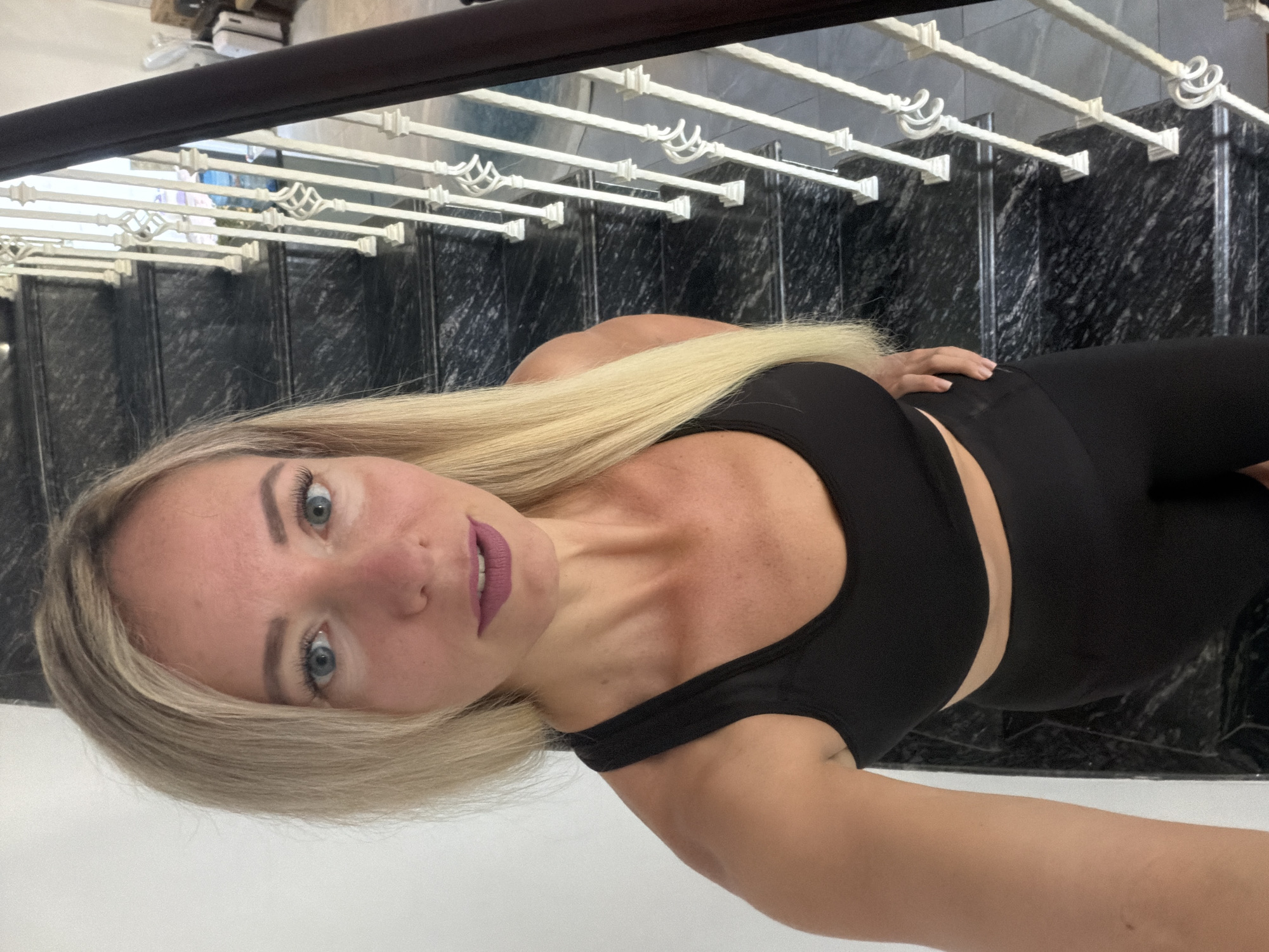 Posed on a marble staircase in Đà Lạt, Vietnam