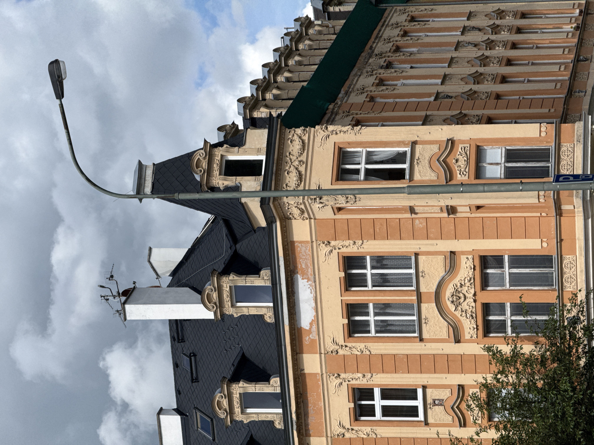 Tourist documents historic Karlovy Vary architecture during afternoon walk