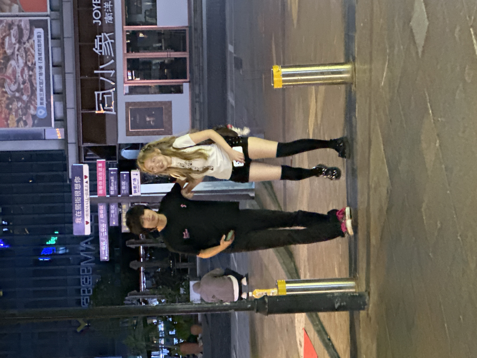 Two people spotted outside building in Chongqing at night