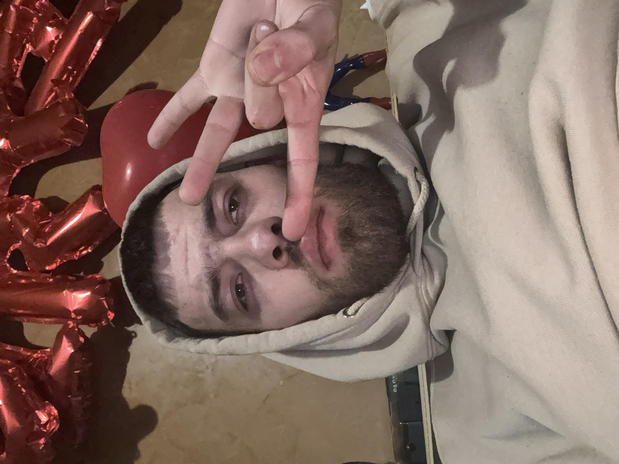 Man makes three-finger gesture amid balloons in Bulgarian village